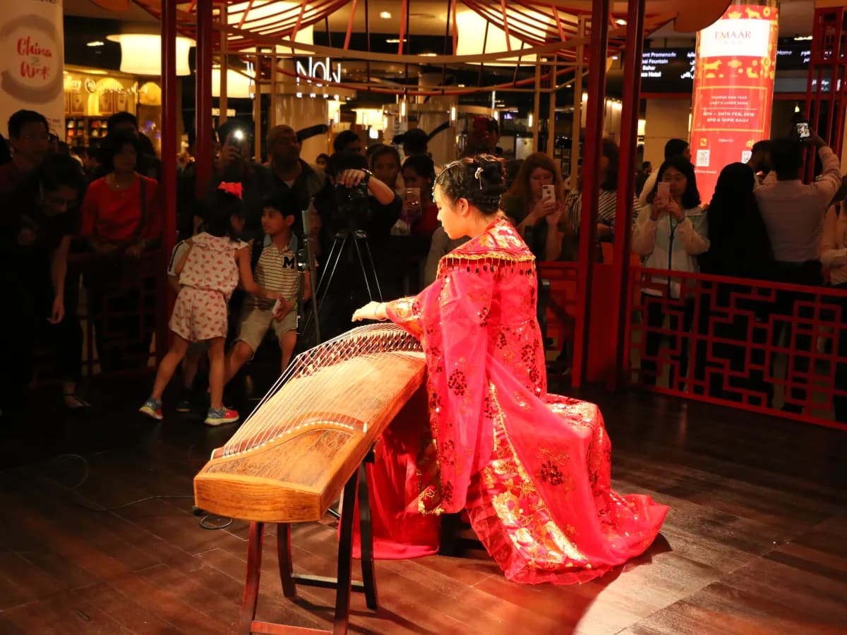 Musician performing on a Chinese guzheng