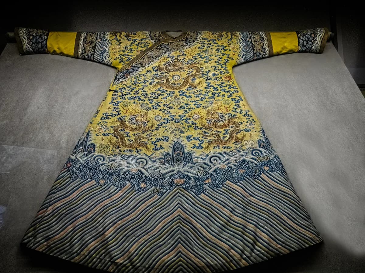 Historic Chinese imperial silk robe displayed in a museum