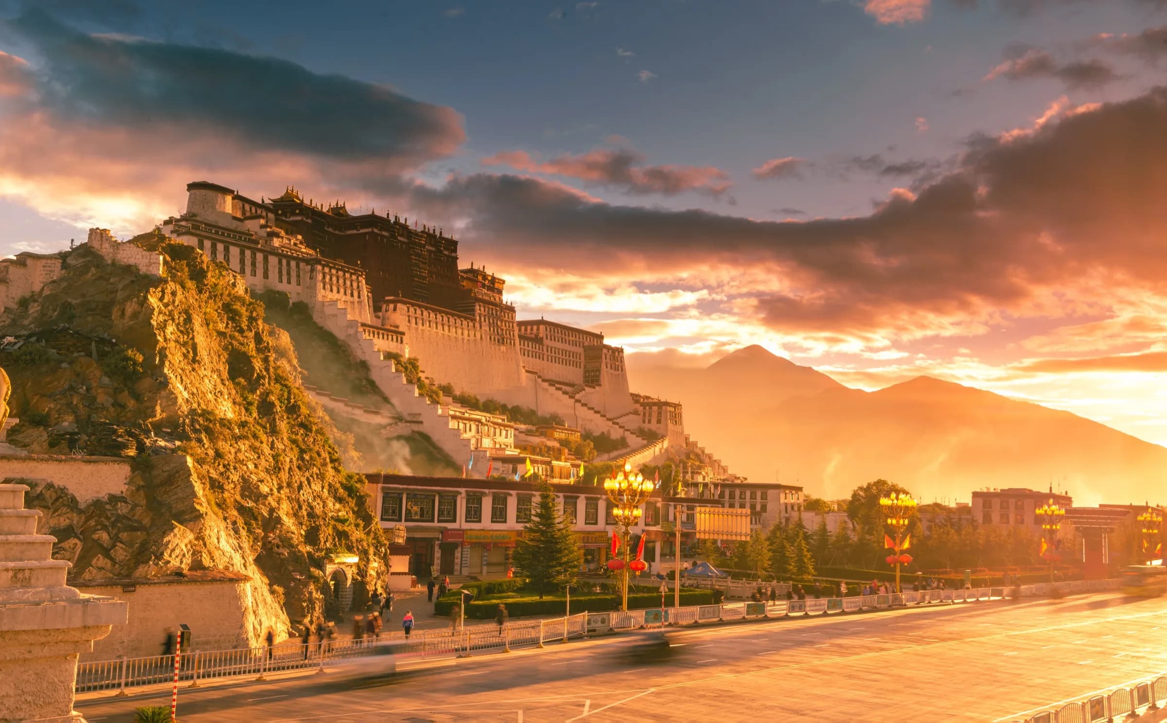 Lhasa culture guide to the Potala Palace rising above the city at sunset
