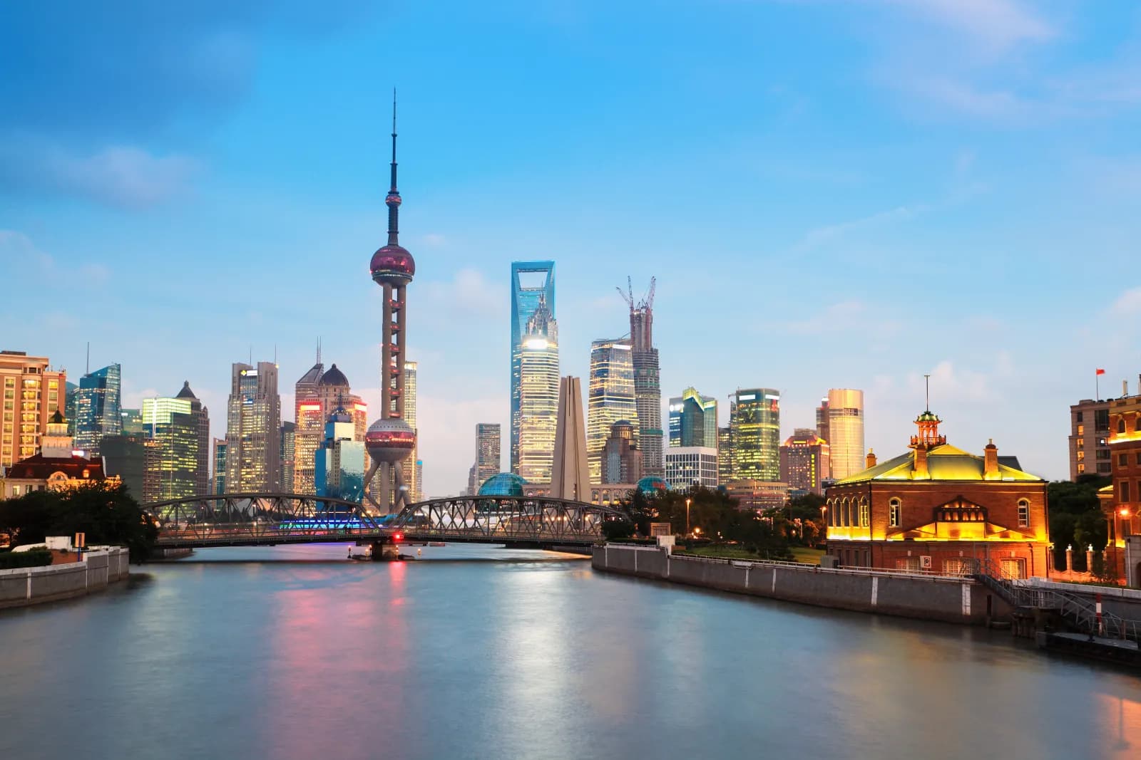 Historic-style roofs, waterways and modern towers showing the layered urban landscape of Jiangnan