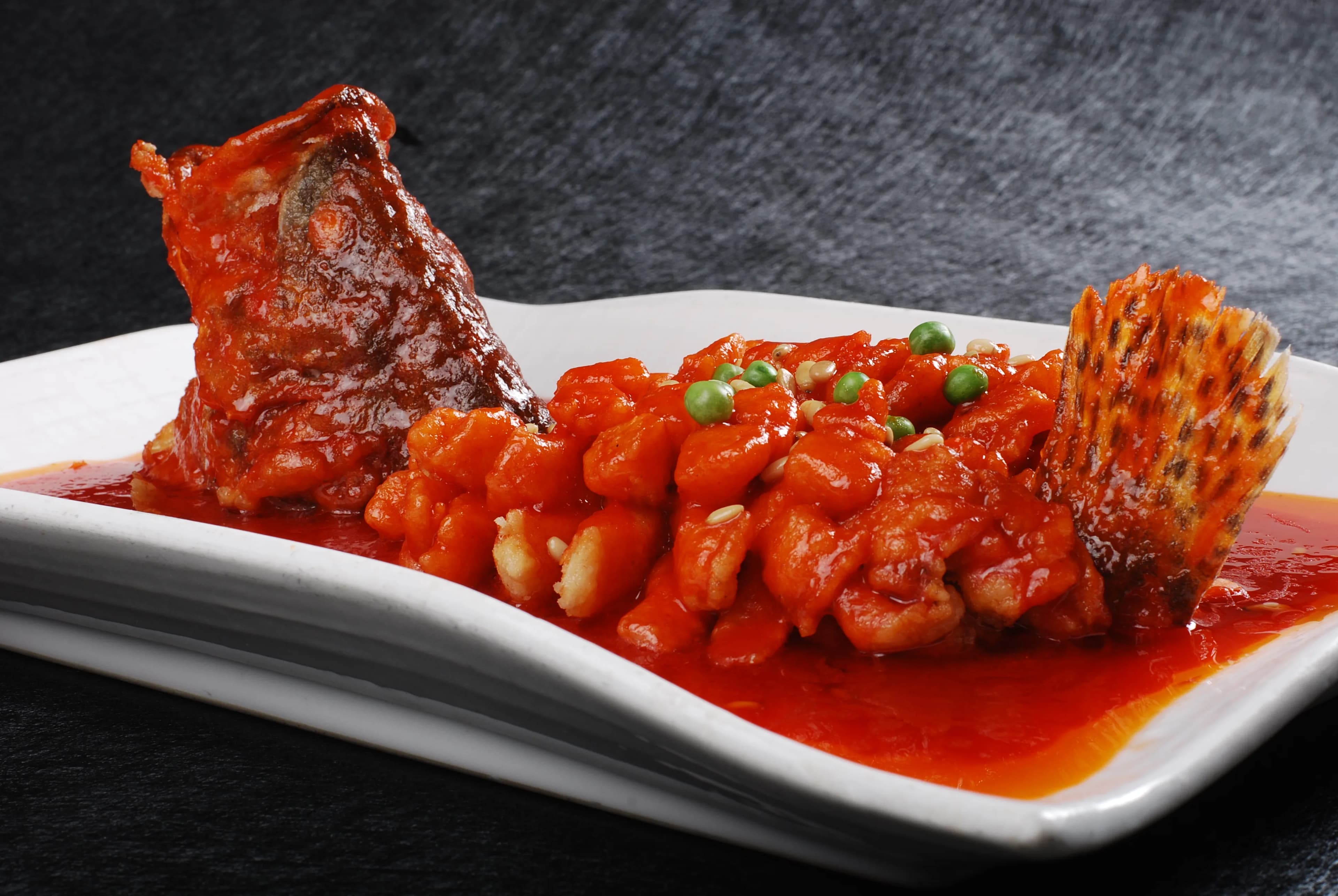 Suzhou-style squirrel mandarin fish cut into crisp sections and coated in bright sweet-sour sauce