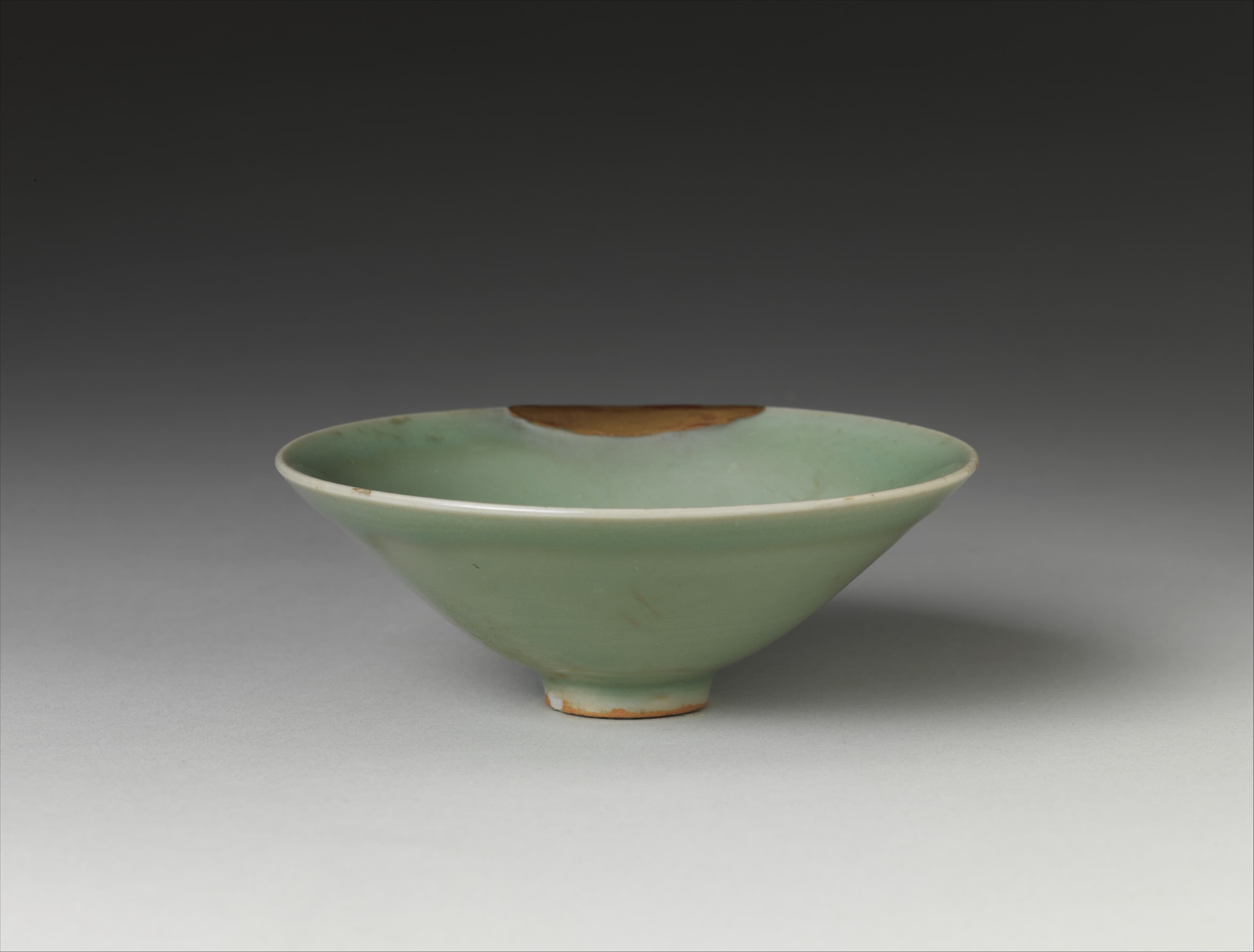 Chinese tea served in a dark glazed tea bowl, showing the quiet material beauty of traditional Chinese tea culture