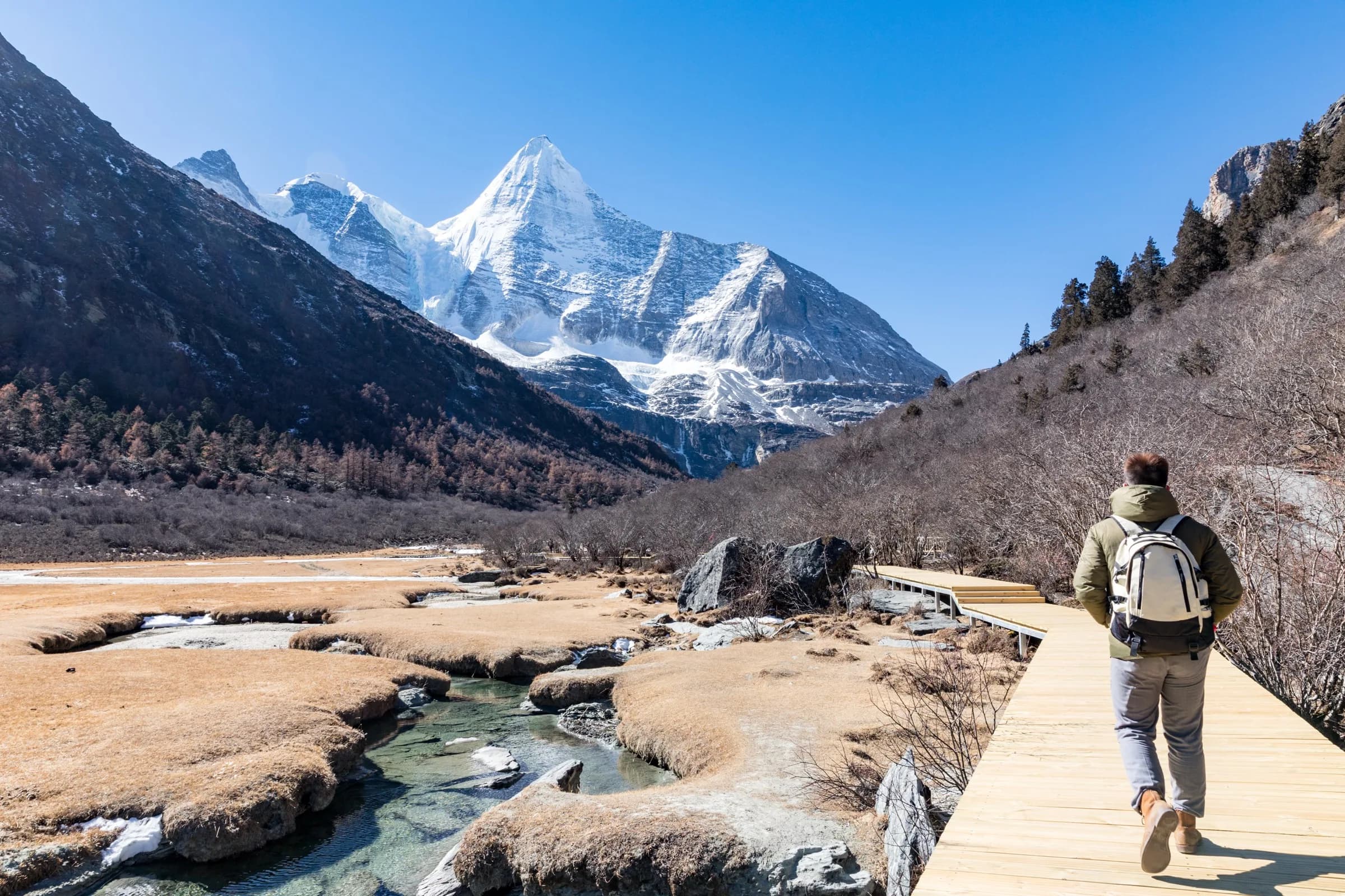 Travel to Daocheng Yading beneath the snow-covered Yangmaiyong peak