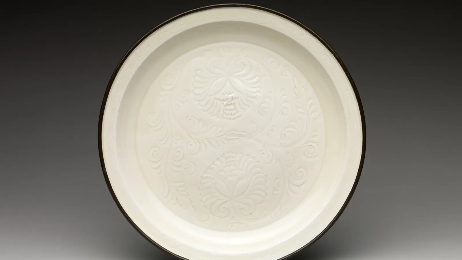 Ding ware white porcelain plate with incised chrysanthemum decoration and a copper rim