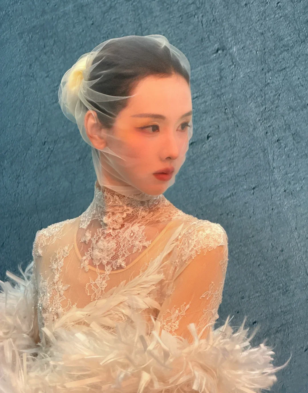 Chen Duling in a 2026 editorial portrait with a blue textured background