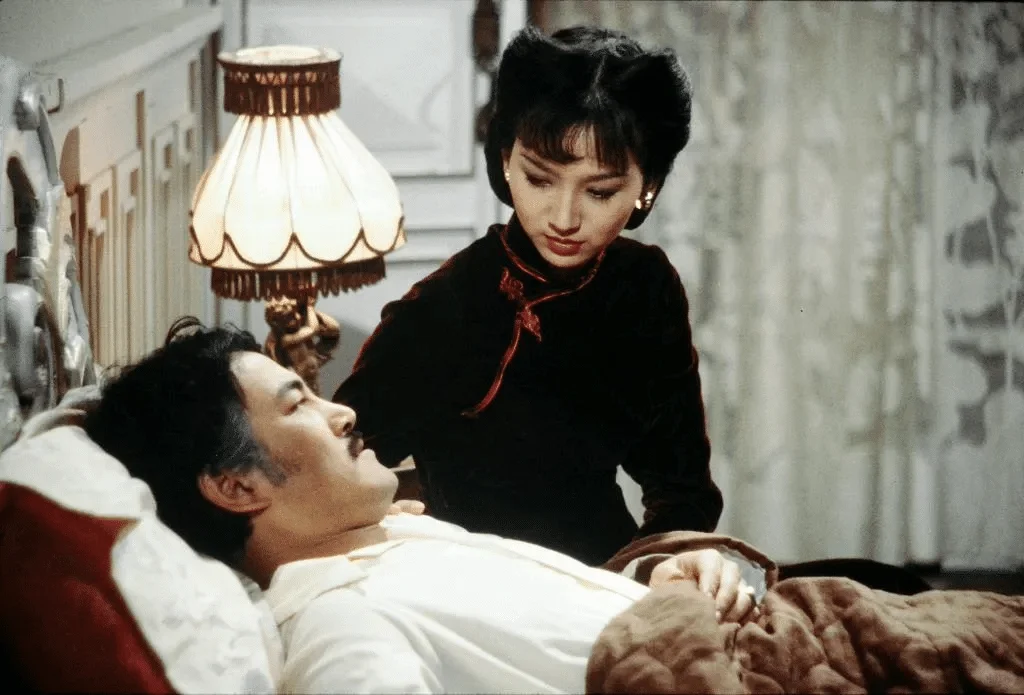 Chow Yun Fat as Hui Man-keung beside Angie Chiu in The Bund
