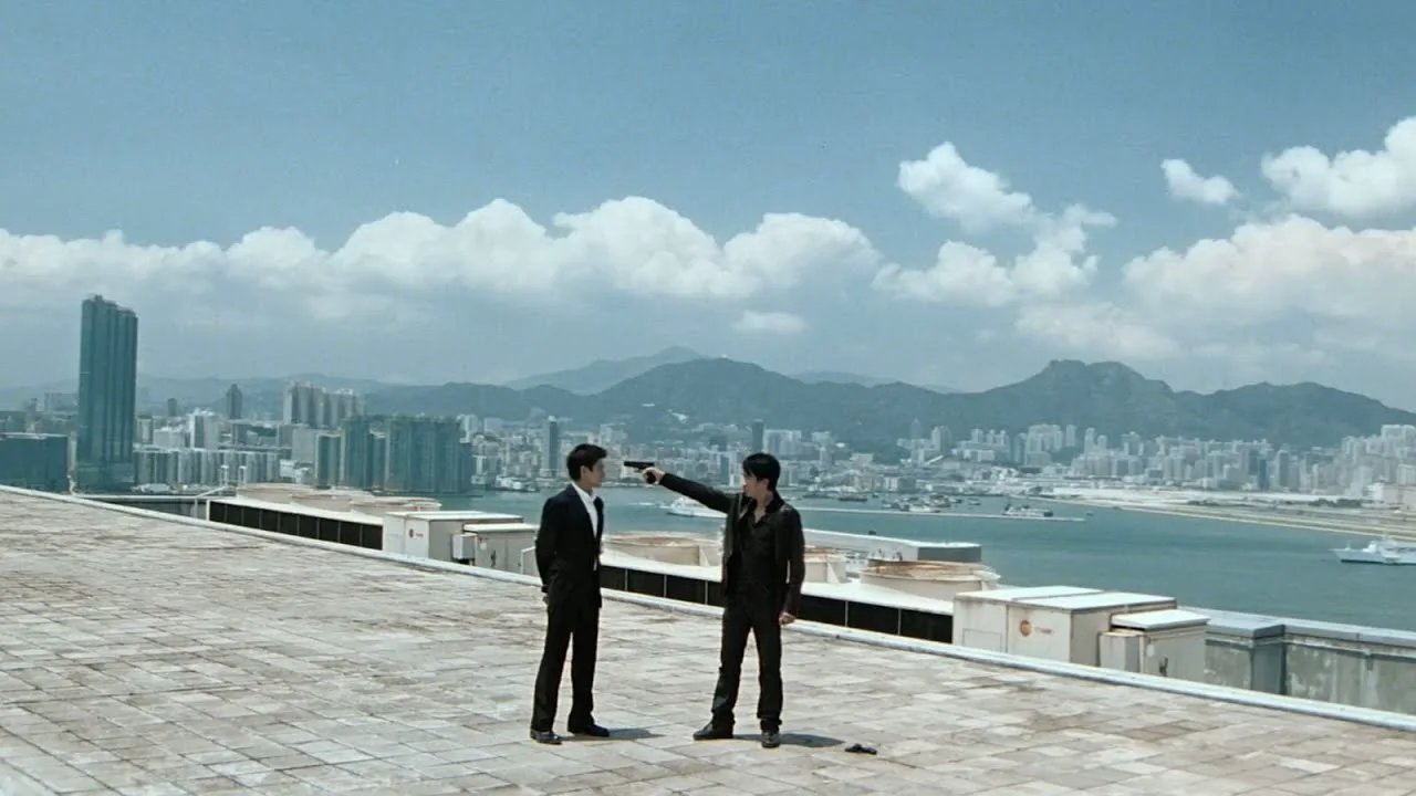 Tony Leung in the Infernal Affairs rooftop confrontation, showing acting through stillness, listening and pressure inside a complete scene