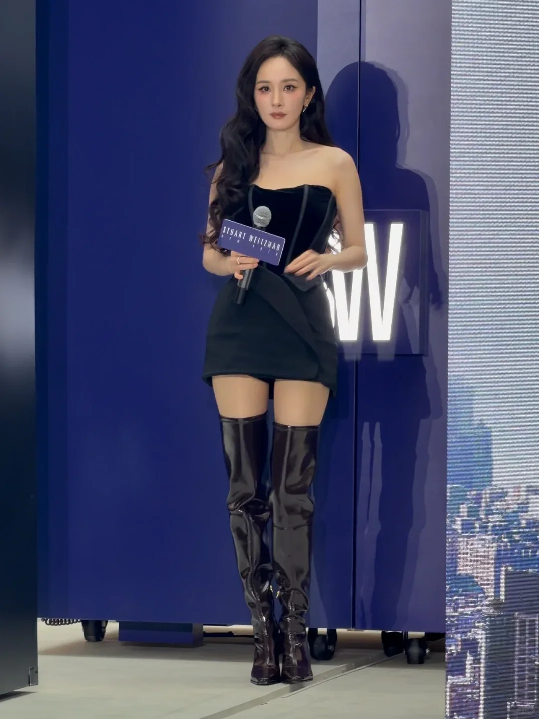 Yang Mi holding a microphone at a 2026 Stuart Weitzman event in Shanghai