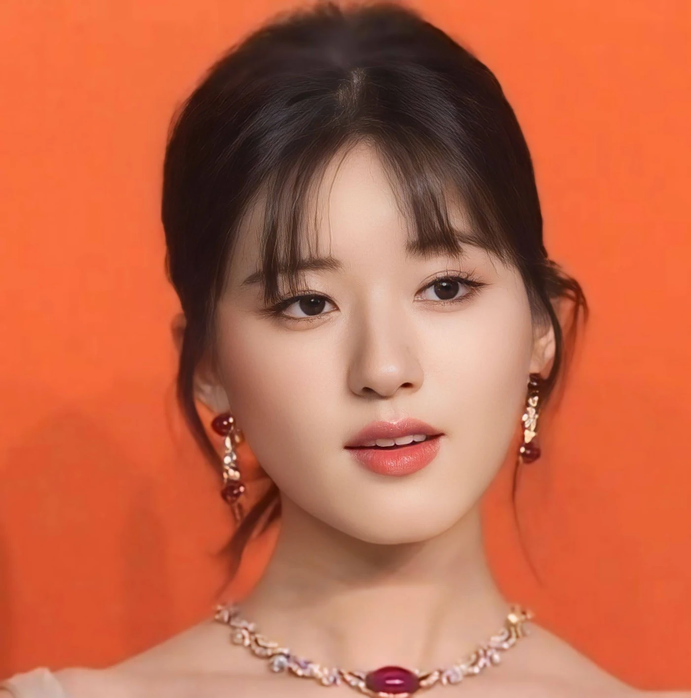 Zhao Lusi in a 2023 public portrait against a vivid orange background