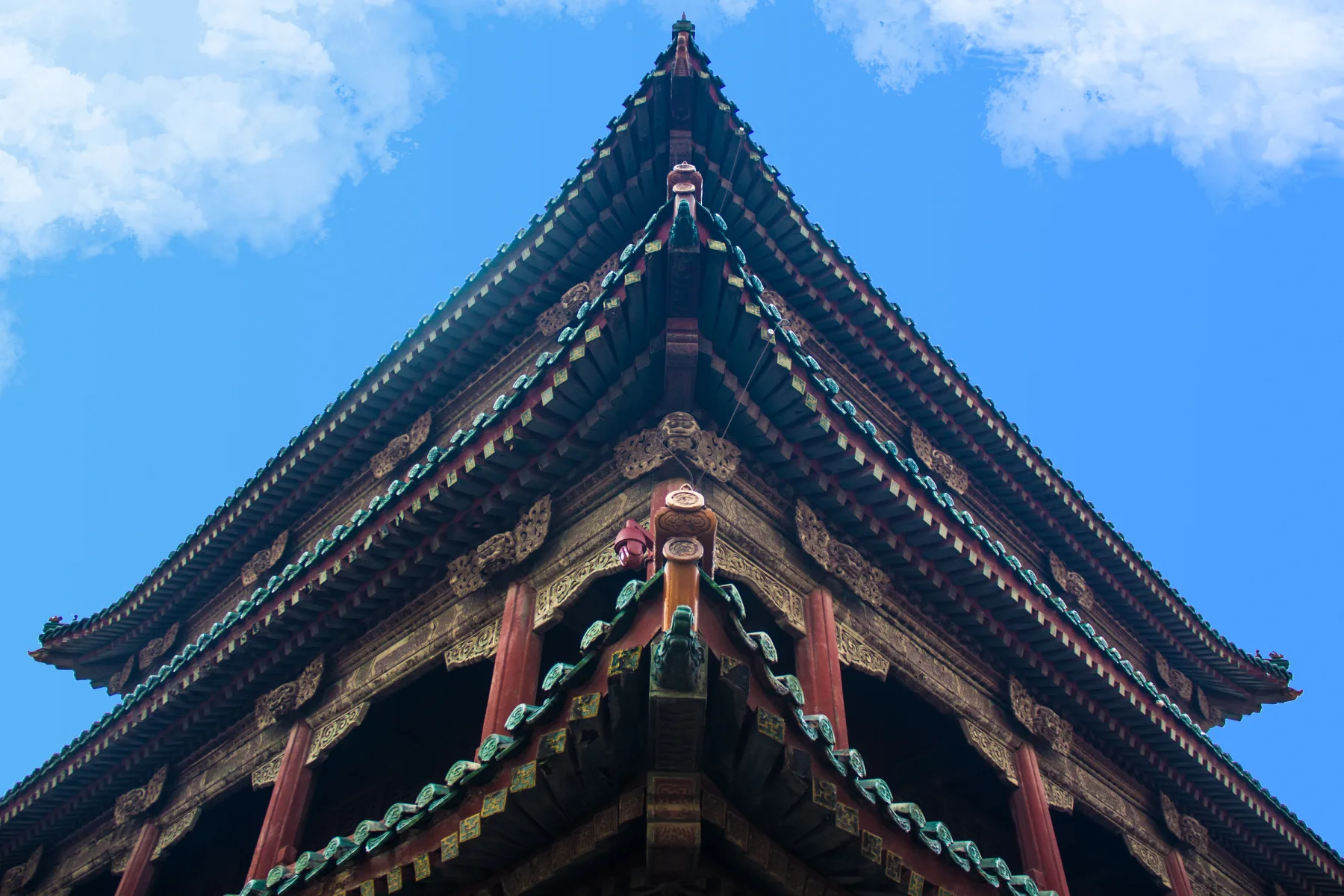Chinese architecture roof detail at the Shenyang Imperial Palace showing layered eaves, timber columns and painted structural decoration