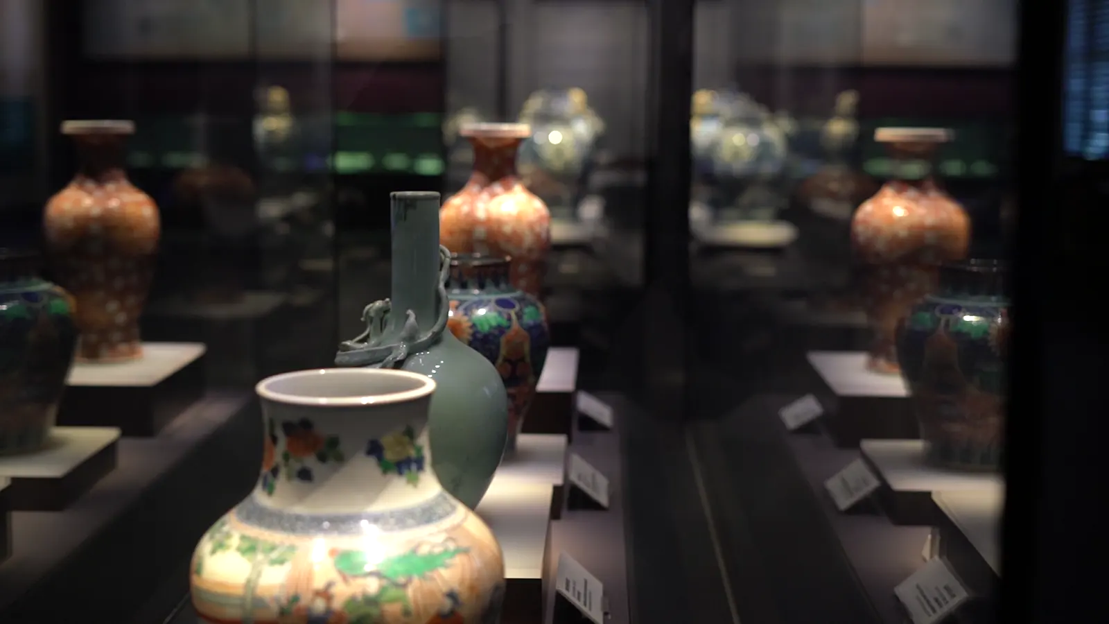 Chinese ceramic vessels displayed in a museum, separated from their original uses but open to close comparison