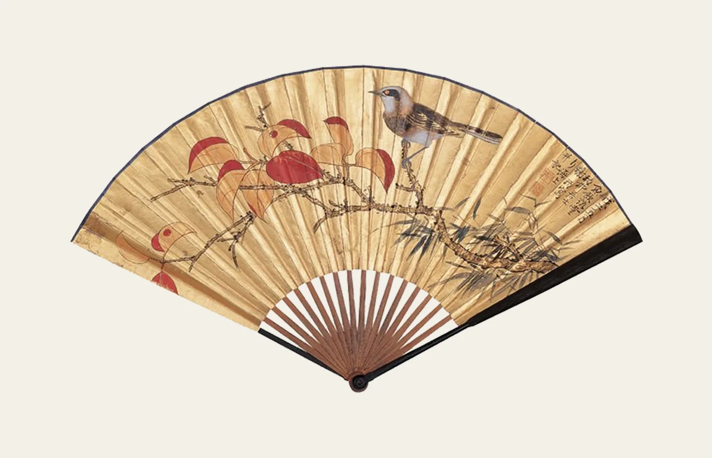 A Chinese folding fan with birds and flowers painted across a warm-toned leaf