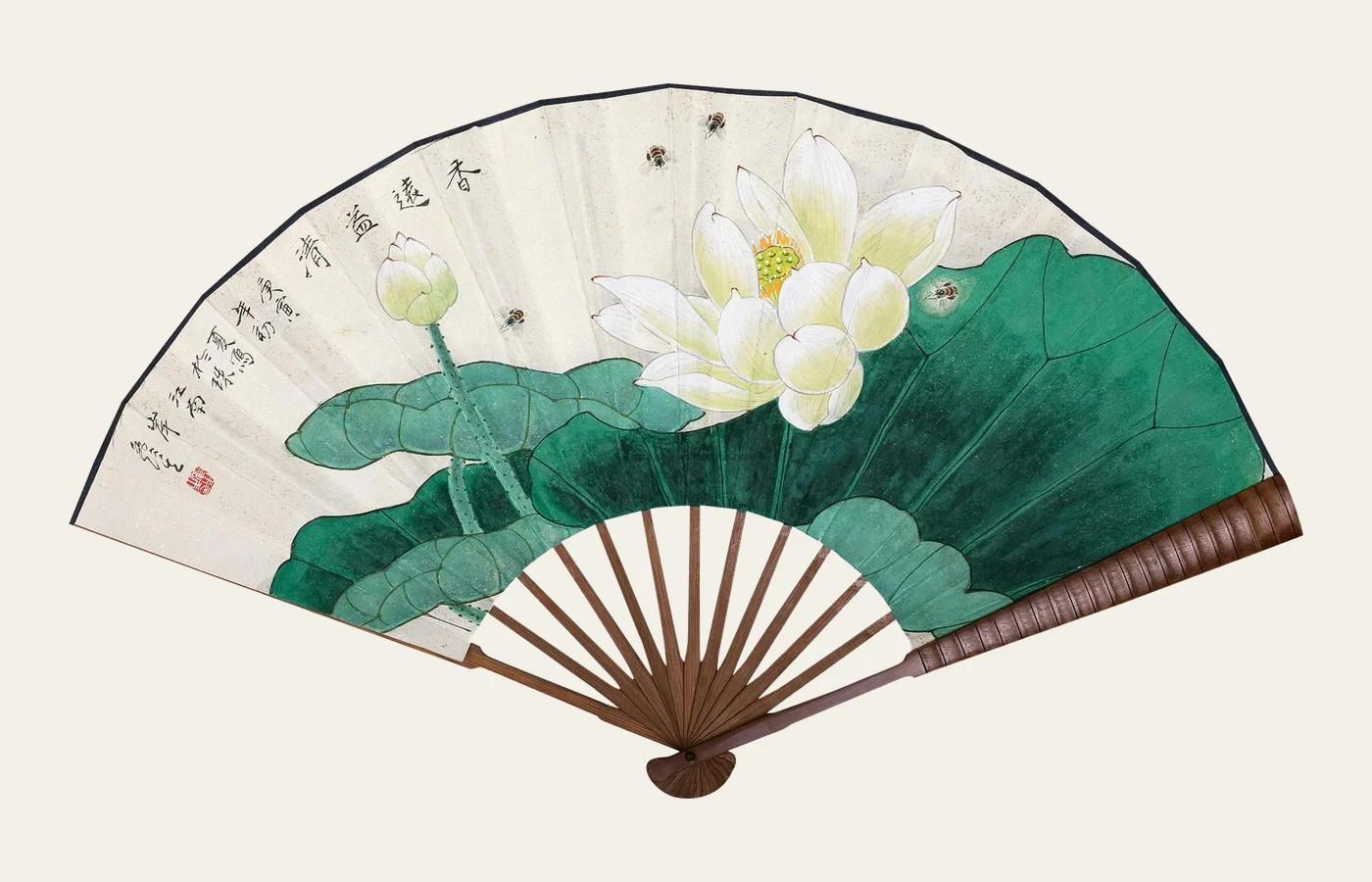 A Chinese folding fan painted with lotus flowers, broad green leaves and a calligraphic inscription