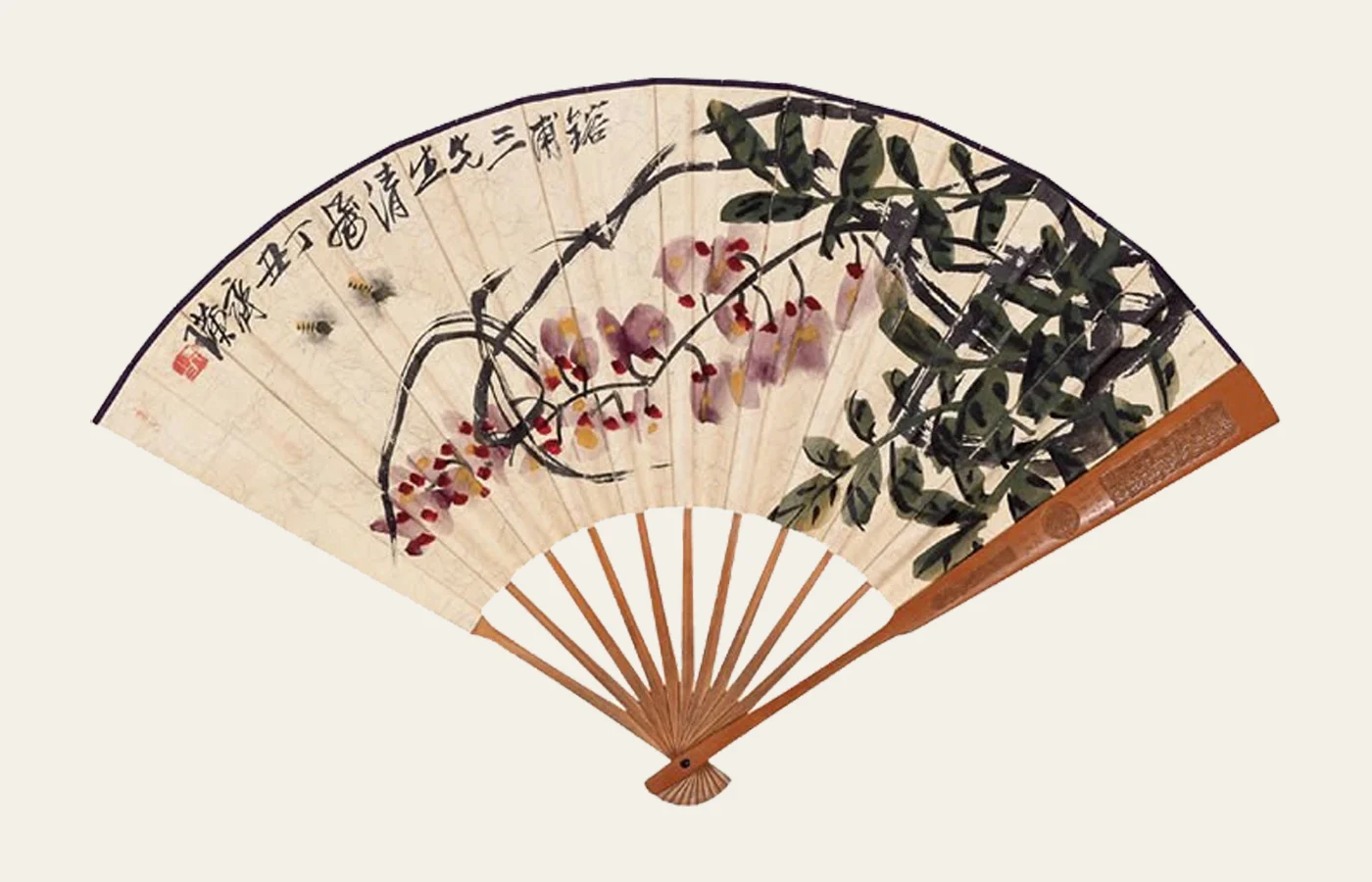 A Chinese folding fan combining orchid-like flowers, leaves, ink writing and red seals