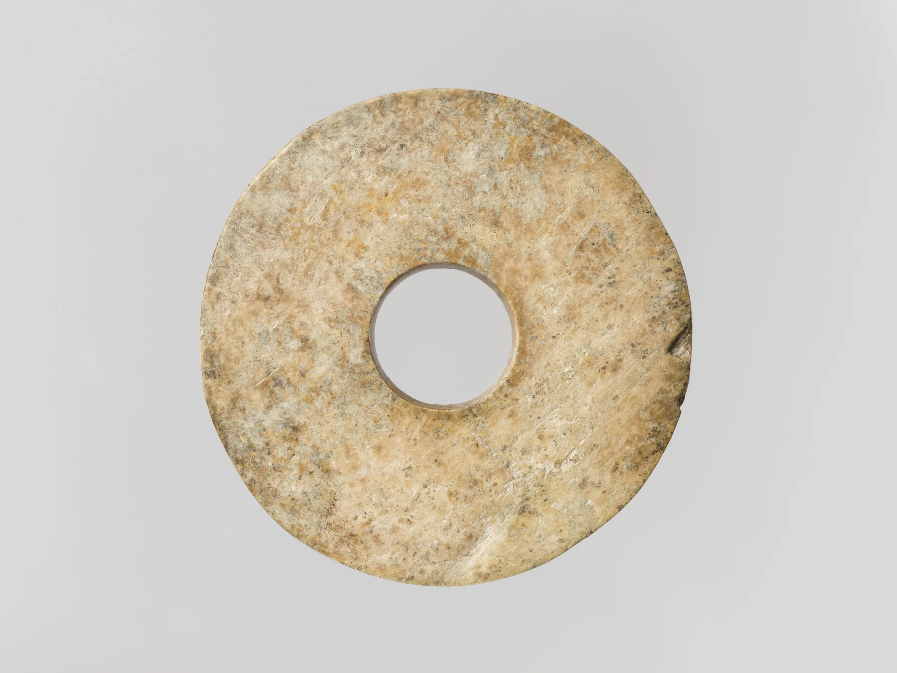 Ancient Chinese nephrite bi disk with a broad undecorated ring and central opening