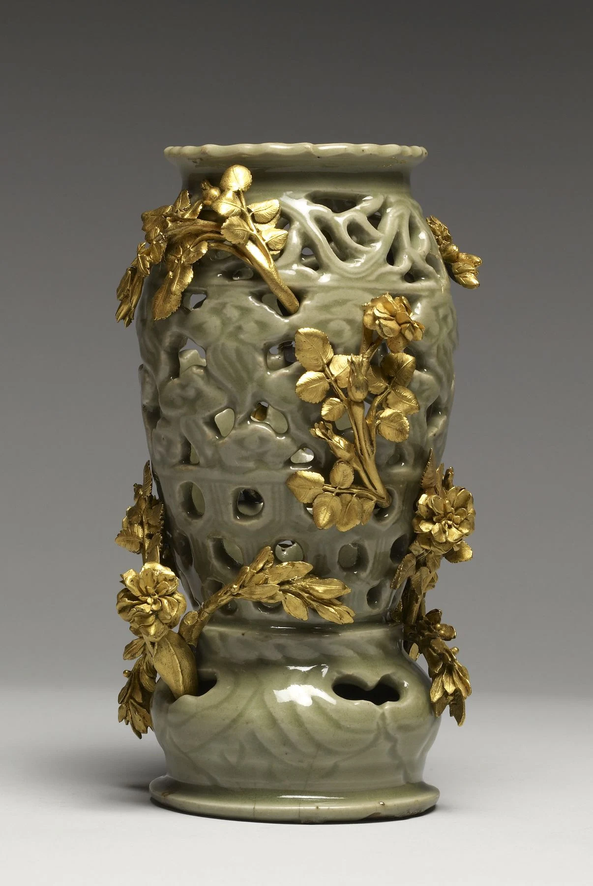 Pierced Longquan celadon lamp with French gold-colored floral mounts wrapping around the ceramic body