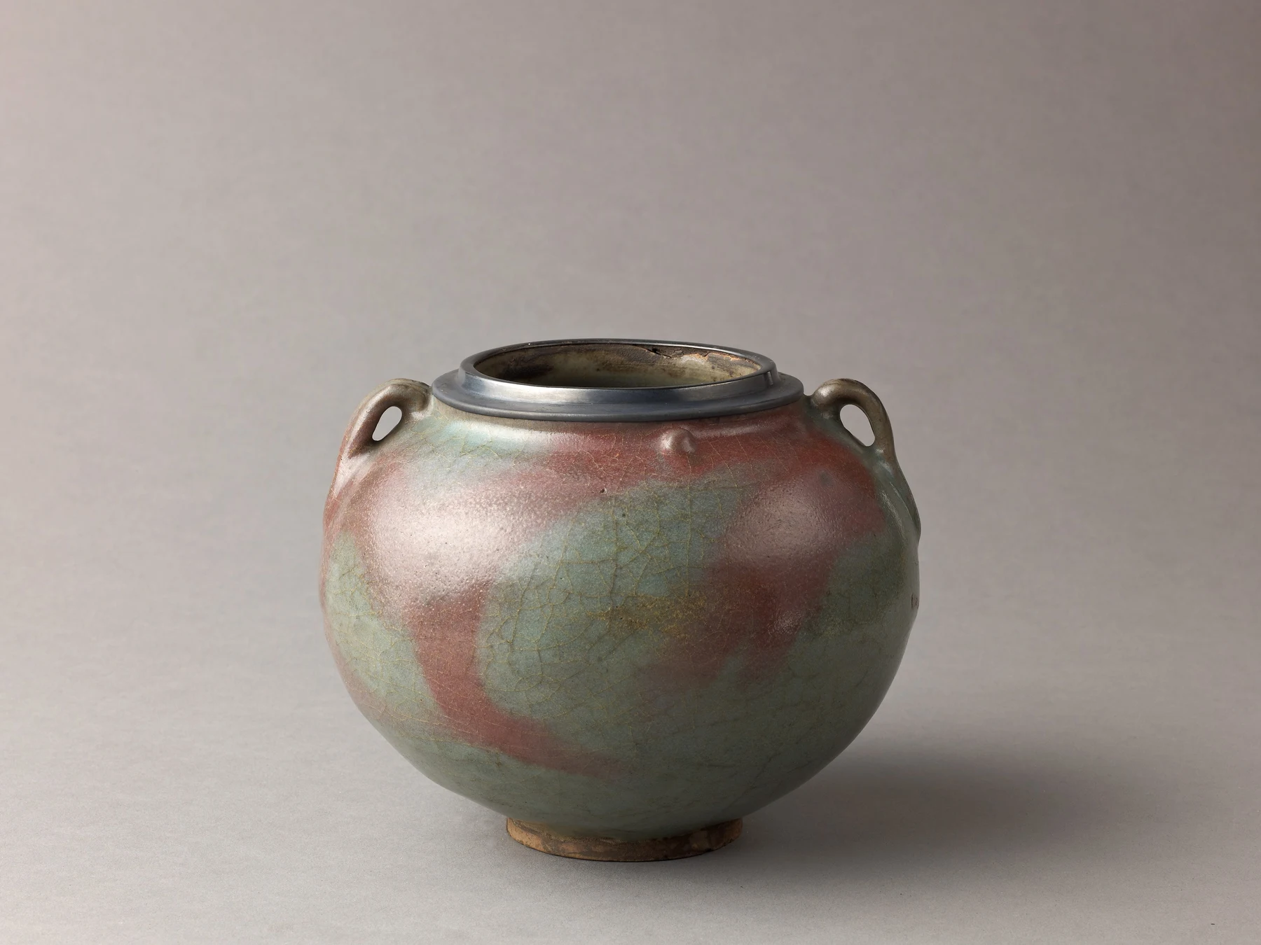 Jun ware two-eared jar with flushed blue glaze and a compact rounded form