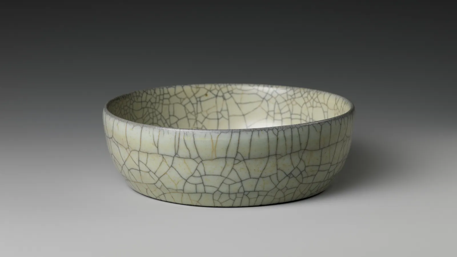 Ge-type brush washer with a pale glaze crossed by a broad dark crackle network