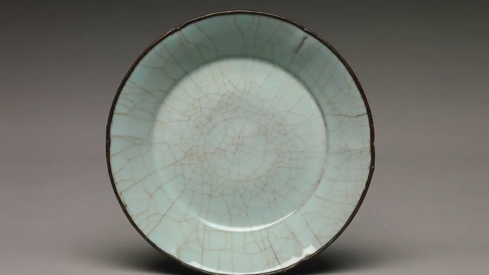 Southern Song Guan ware dish with a blue celadon glaze crossed by an irregular crackle network