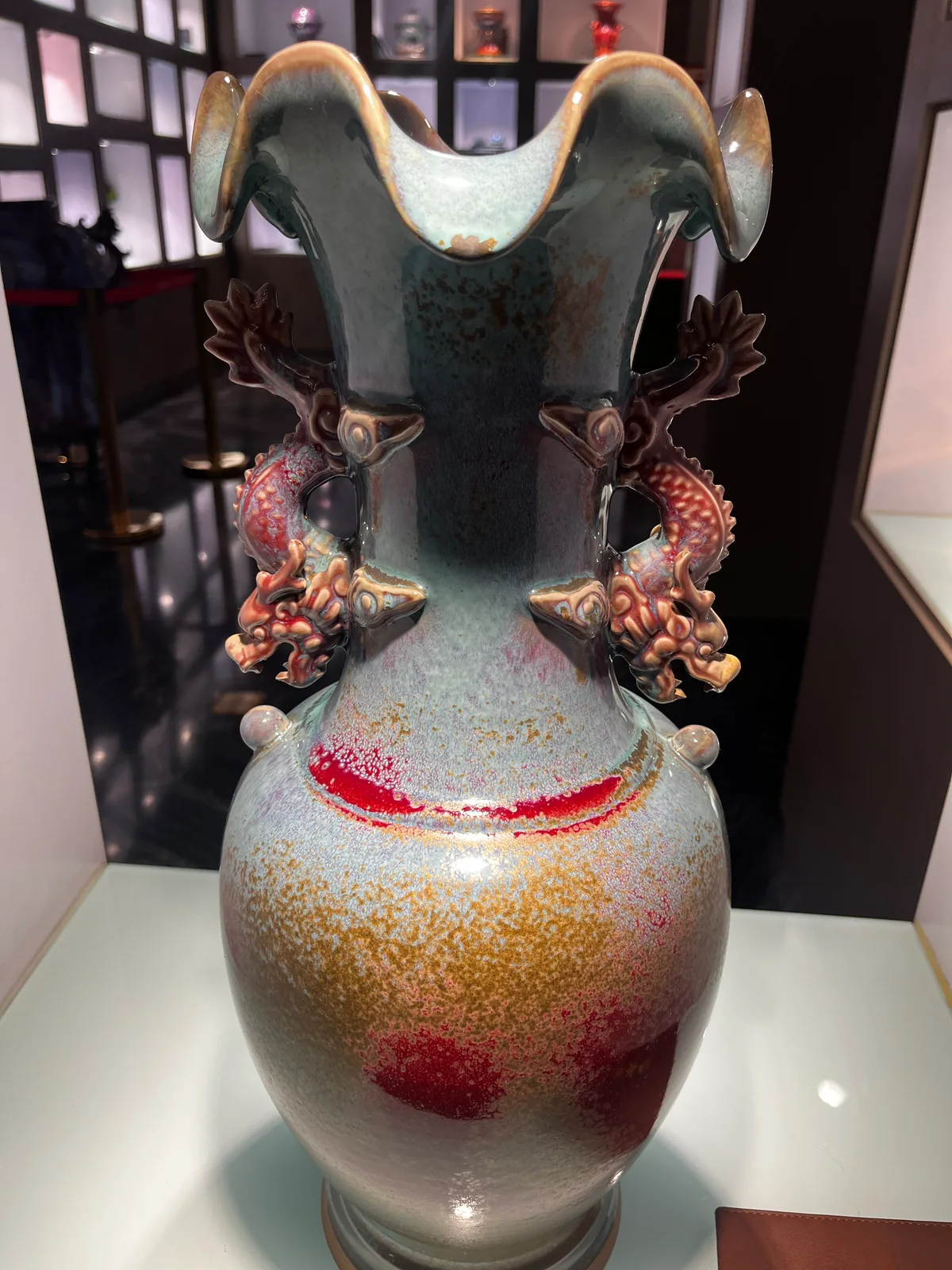 A contemporary ornate Jun-style handled vessel with dragon decoration and several glaze colors