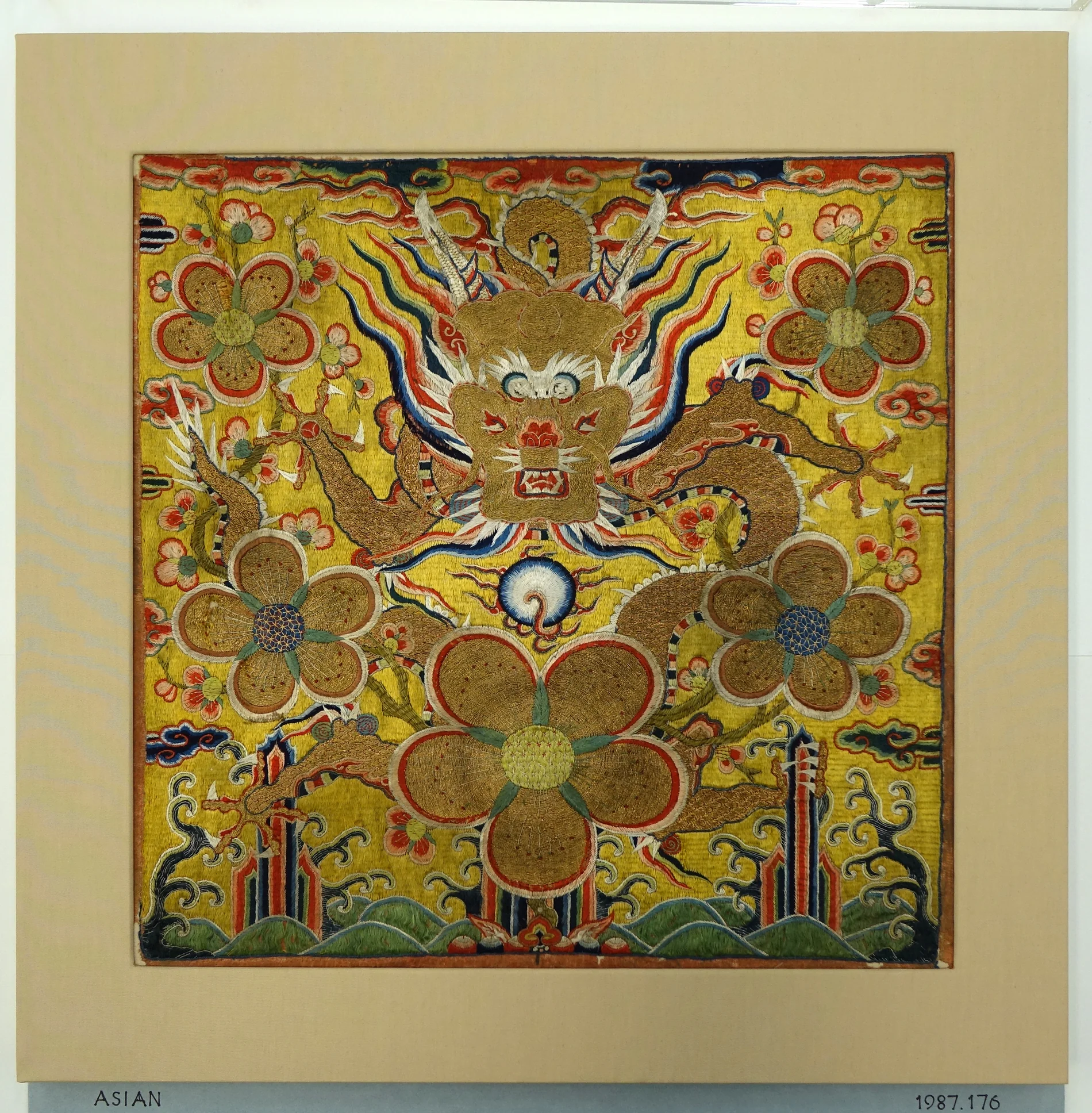 Embroidered Chinese rank badge with a gold dragon, plum blossoms, flames and waves