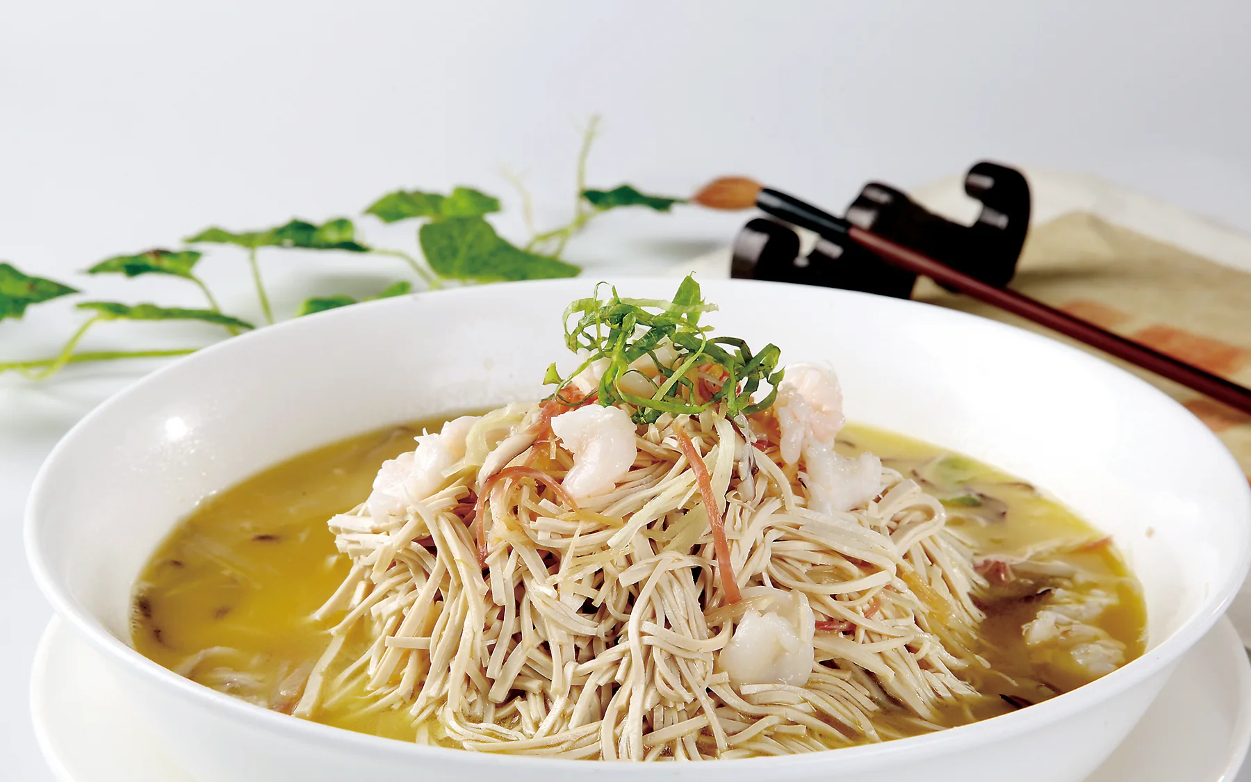 Fine Yangzhou shredded tofu in broth showing why knife work and stock belong in the same judgment
