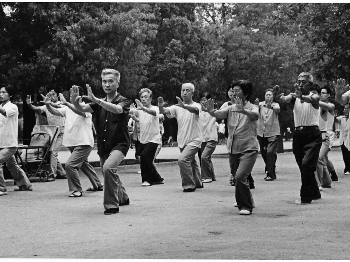 Tai chi practitioner maintaining an upright torso and controlled stance during slow form training
