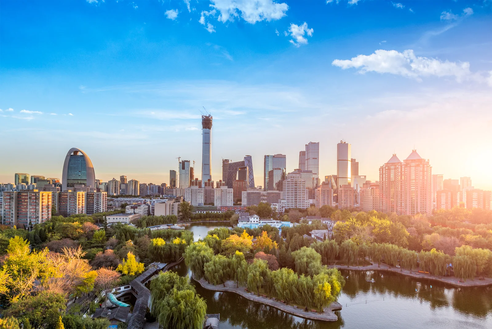 Modern Beijing skyline rising beyond the trees and public green space that make the capital livable
