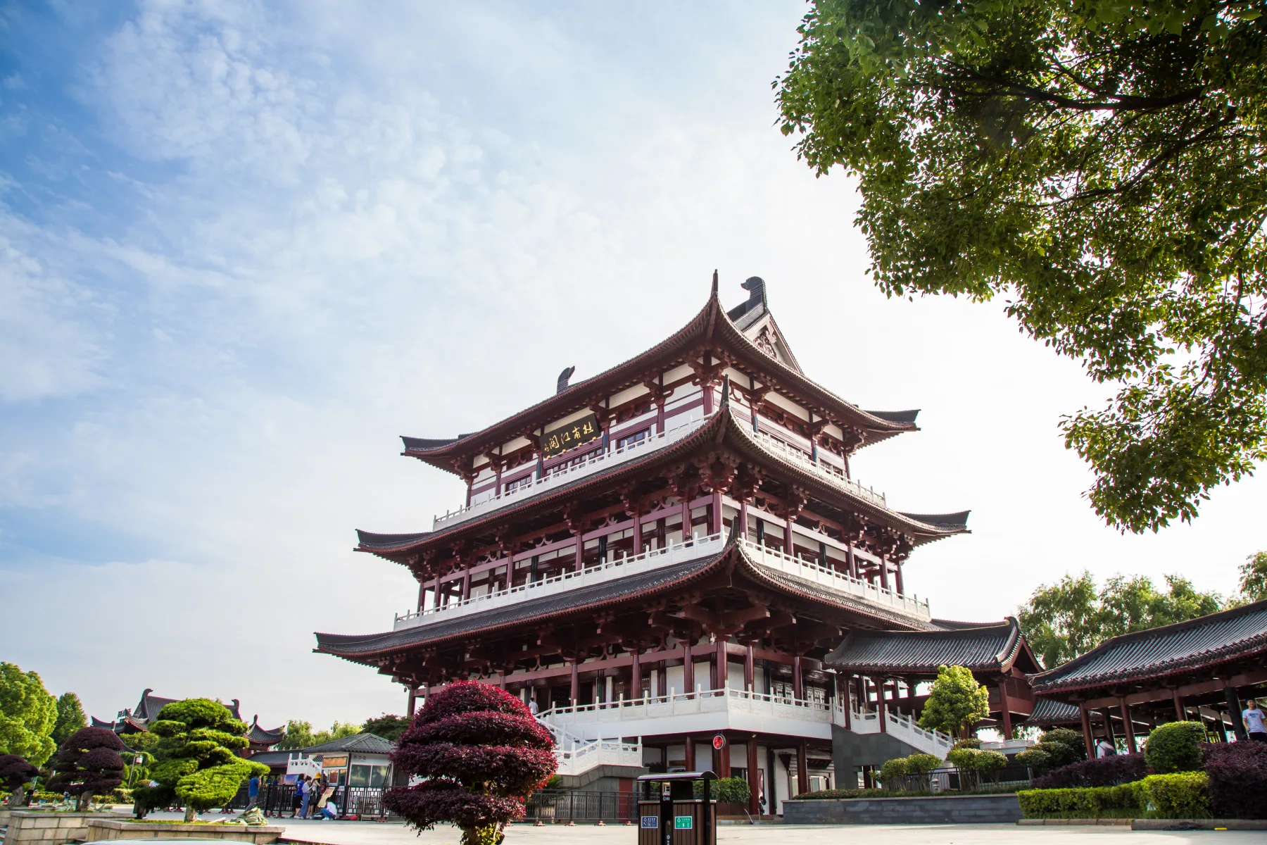 Side view of the reconstructed Du Fu River Pavilion beneath a bright sky