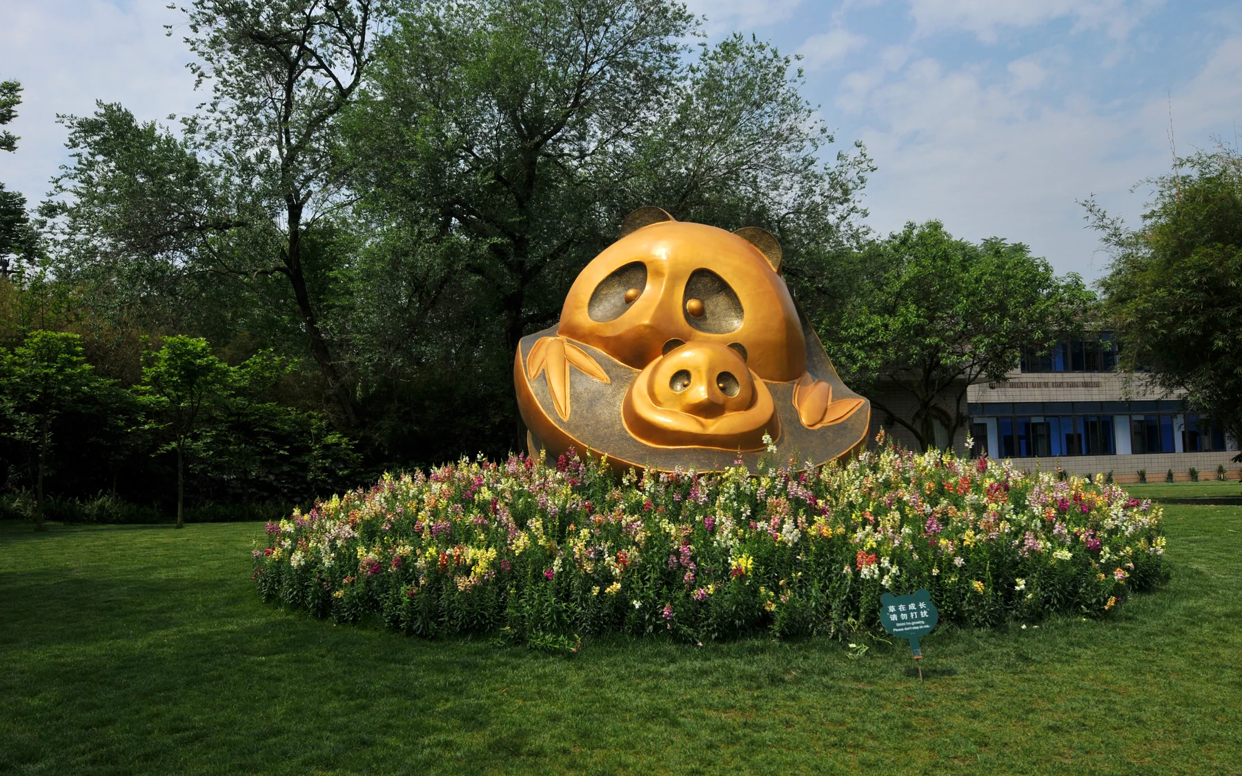A panda-themed sculpture and garden setting at a Chengdu panda research site