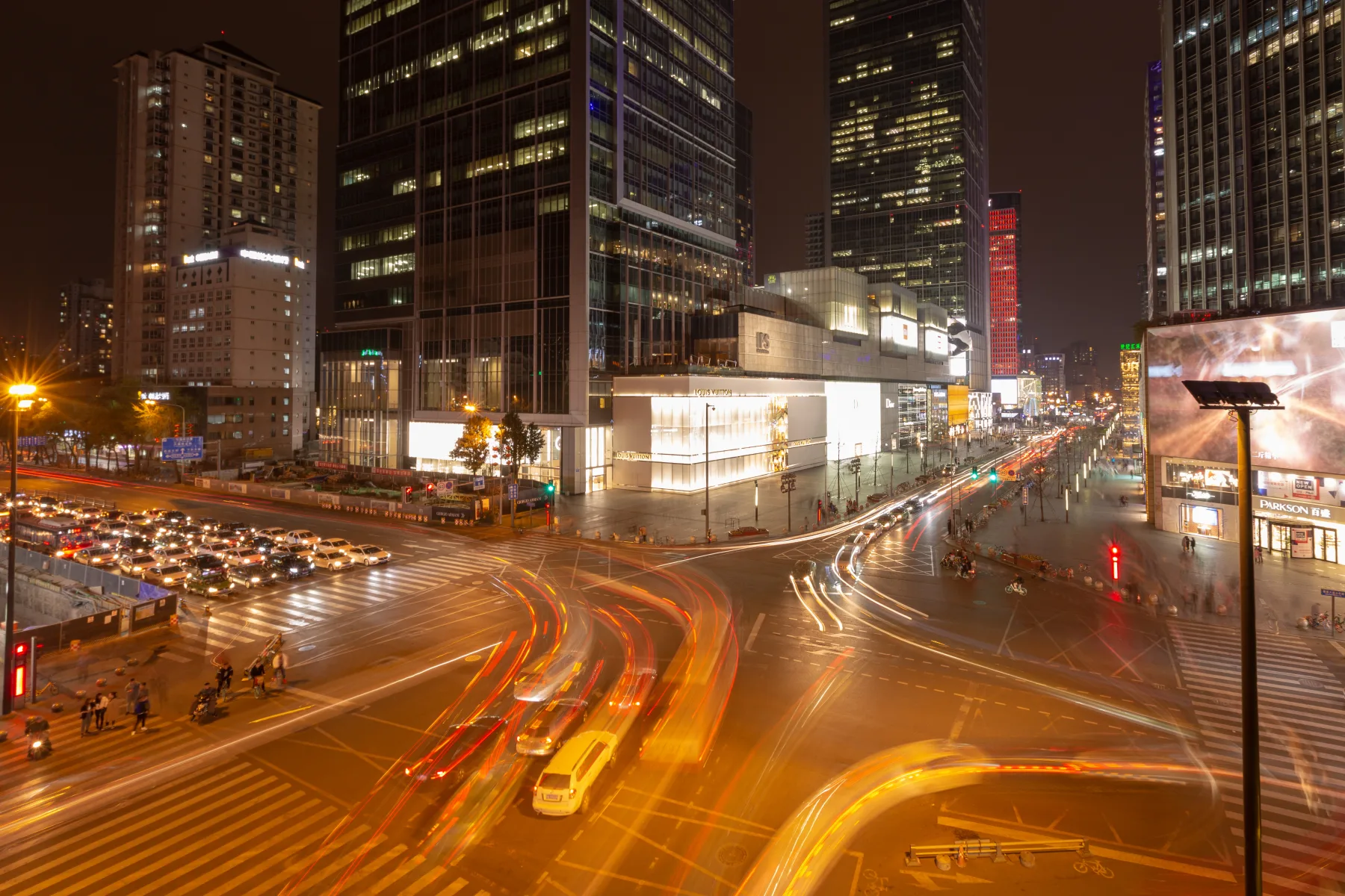 Crowds and large commercial facades around the Chunxi Road and IFS intersection