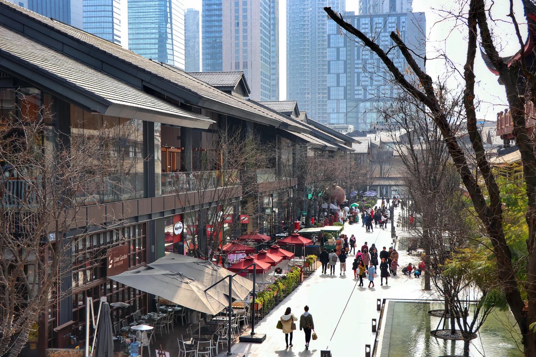 Pedestrians and contemporary retail architecture along a Chengdu Taikoo Li street