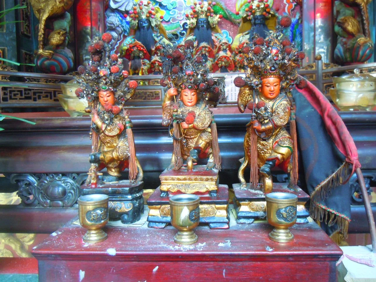 Three youthful marshal figures, including a Nezha devotional figure, on the altar at Jia'an Temple