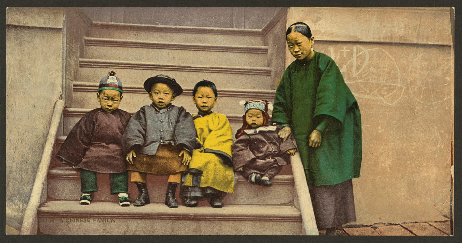 An adult and four children posed on steps in a California photochrom catalogued as A Chinese family between 1898 and 1905