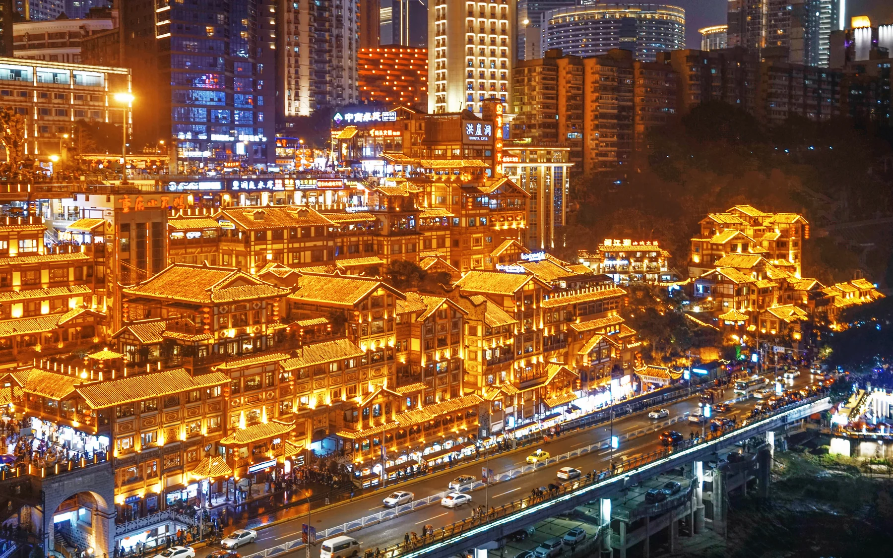 Hongya Cave glowing above Chongqing's layered roads and commercial streets at night