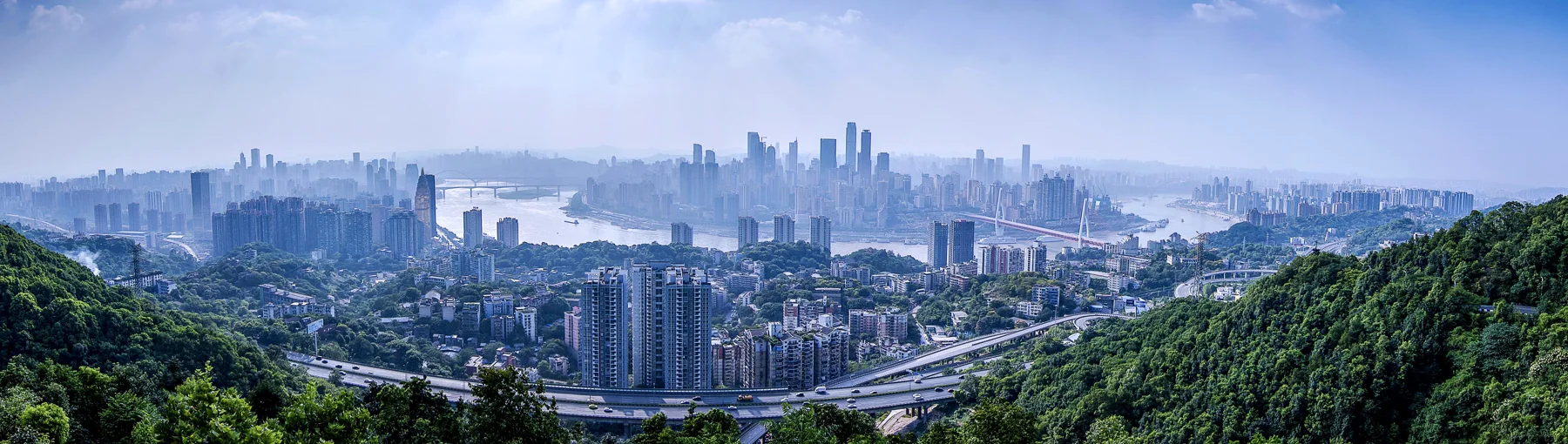 Dense Chongqing districts spread across hills above the river