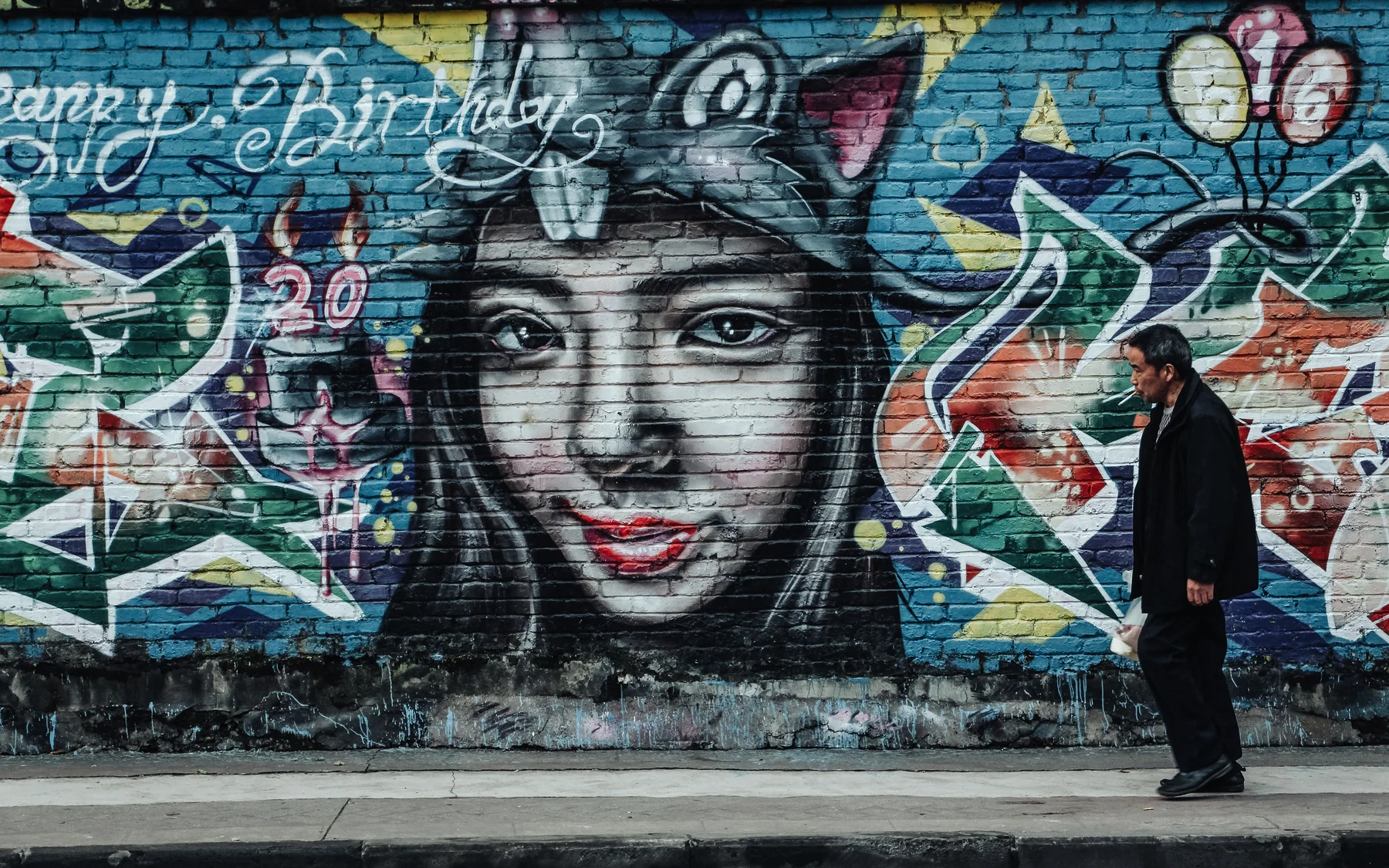 Street art and close-range pedestrian space showing Chongqing culture below the skyline