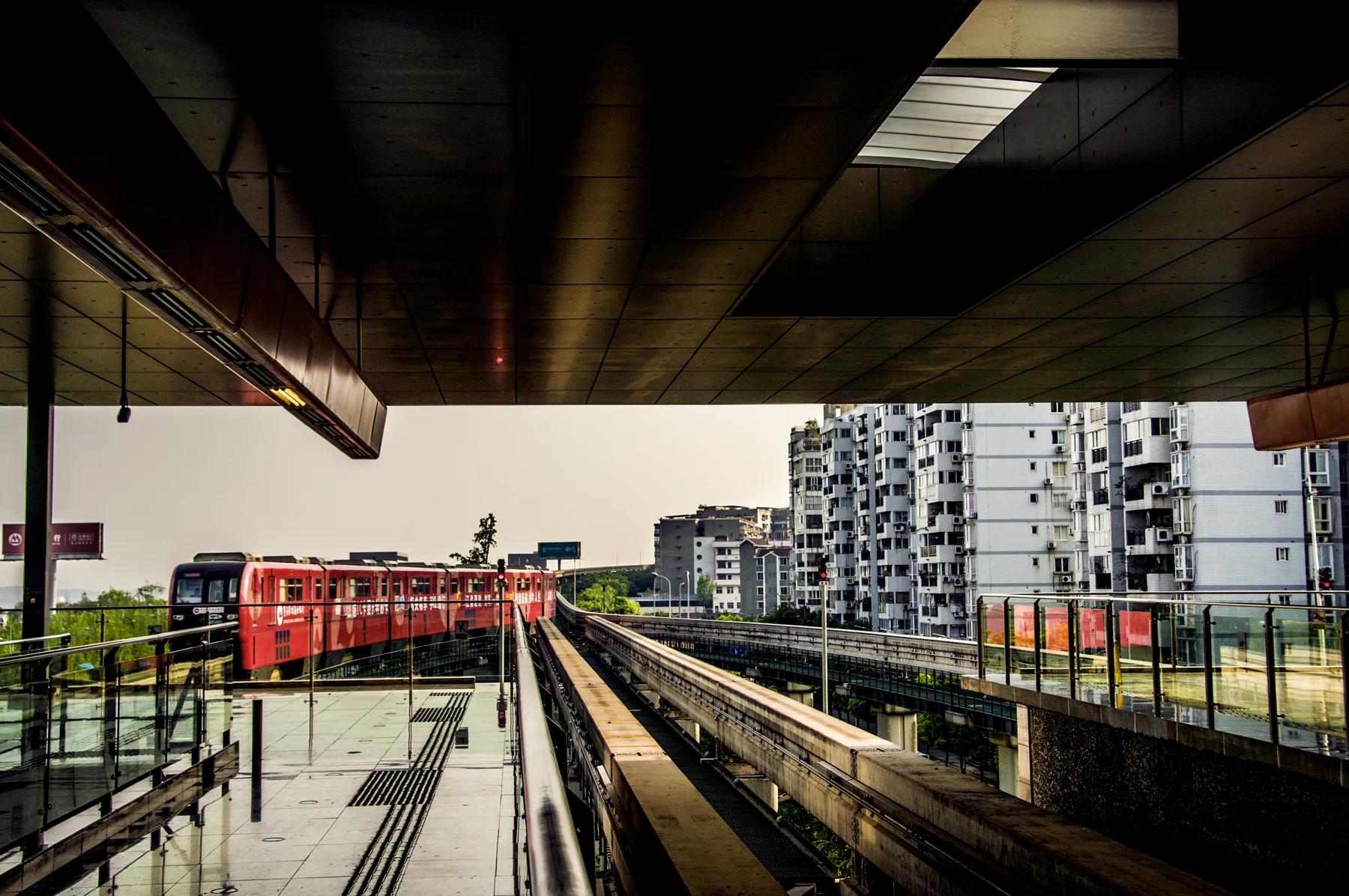 An elevated Chongqing rail station built into a dense residential district