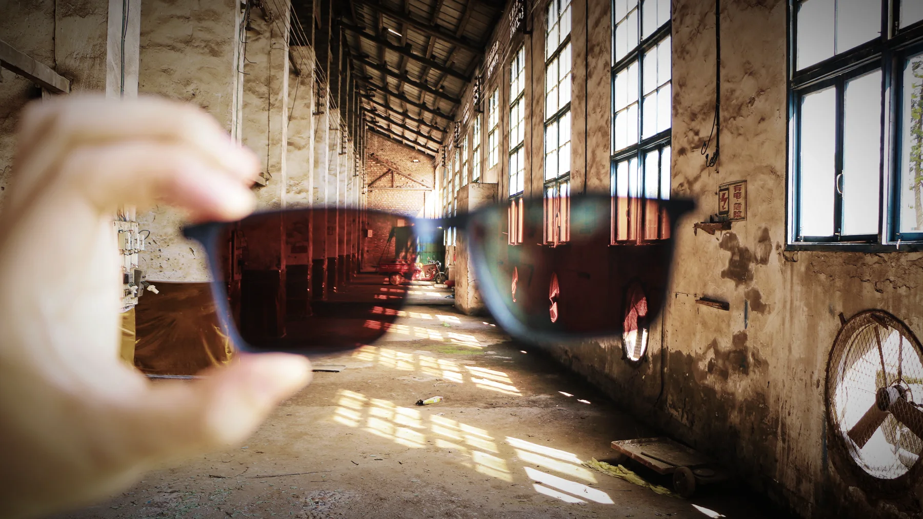 A cup of tea inside a large preserved industrial workshop