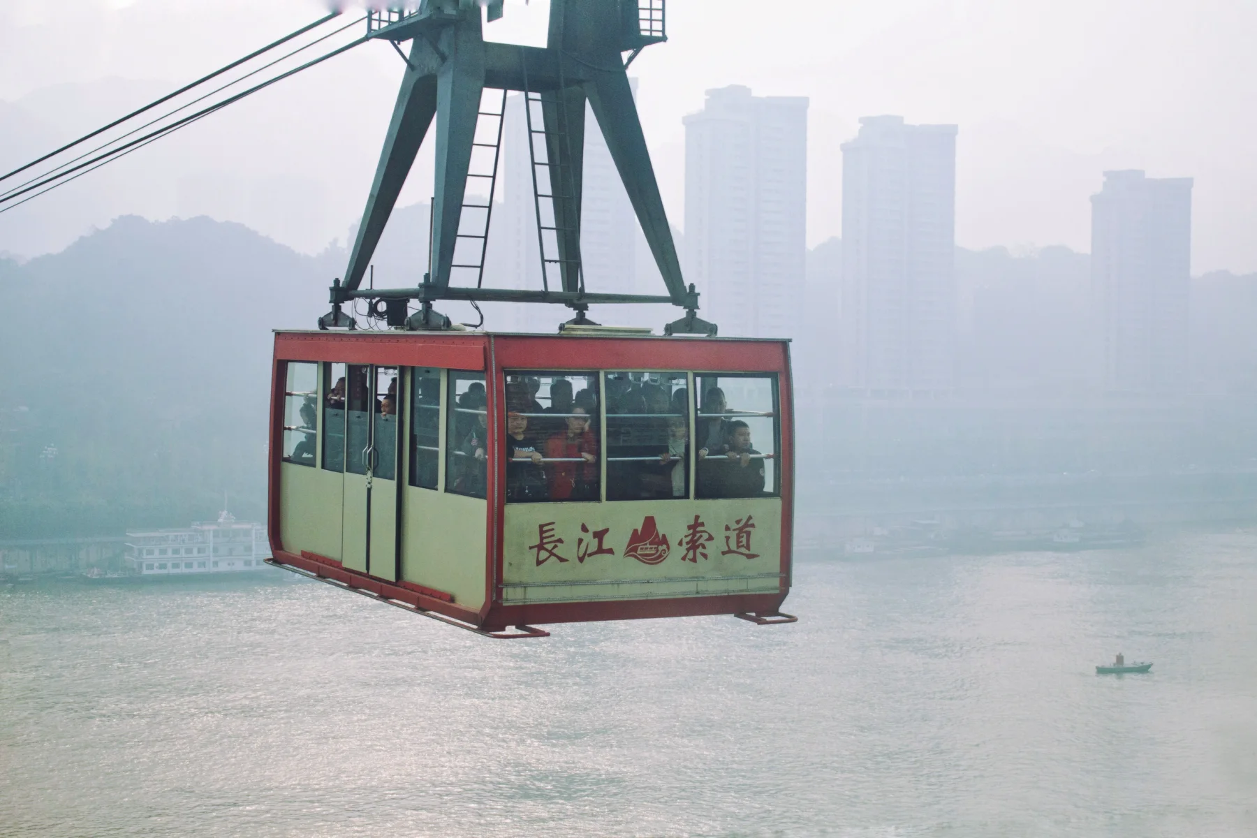 A Yangtze River Cableway cabin suspended above the river in mist