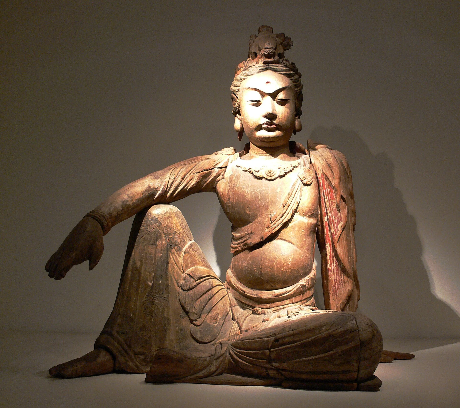 A museum Guanyin figure viewed frontally, making posture and hand position available for close looking