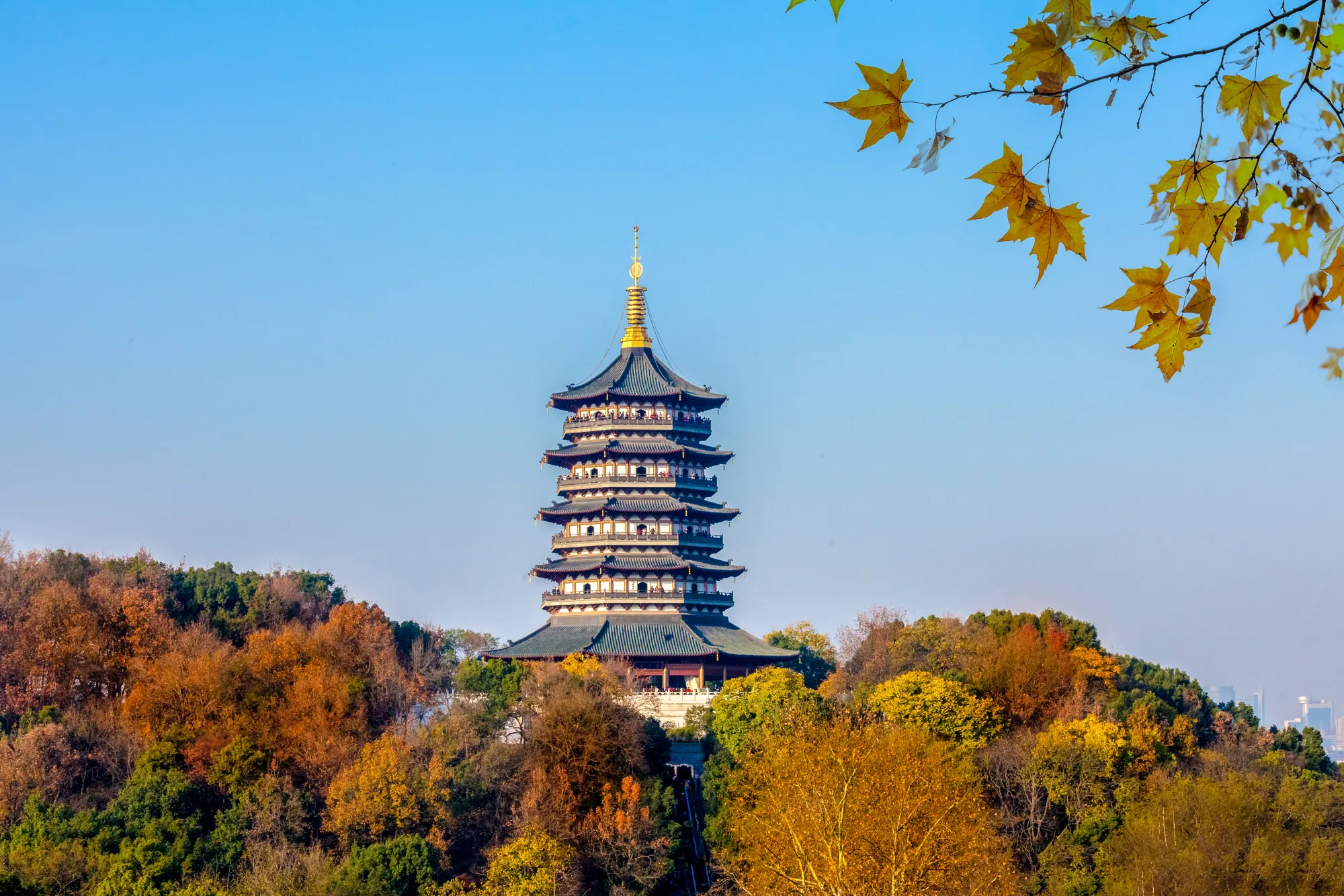 Leifeng Pagoda rising above autumn trees on the south side of West Lake