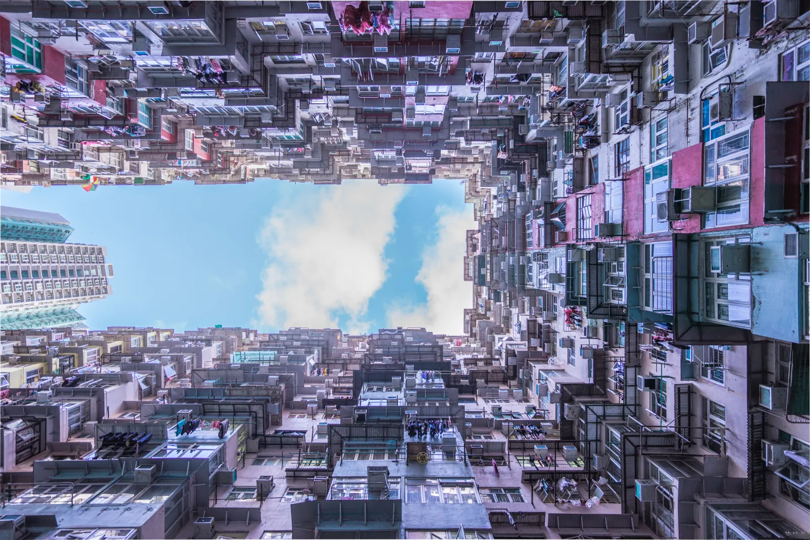 Looking upward through the dense residential courtyard in Quarry Bay
