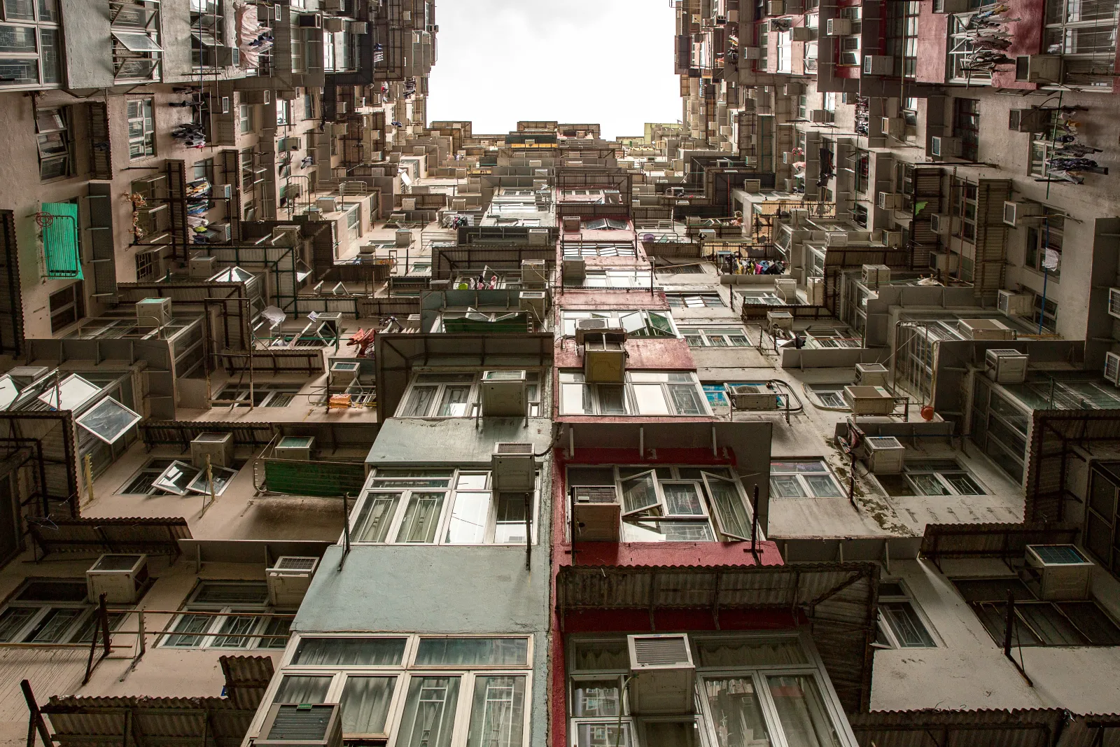 Closely packed residential towers enclosing a narrow open court in Hong Kong
