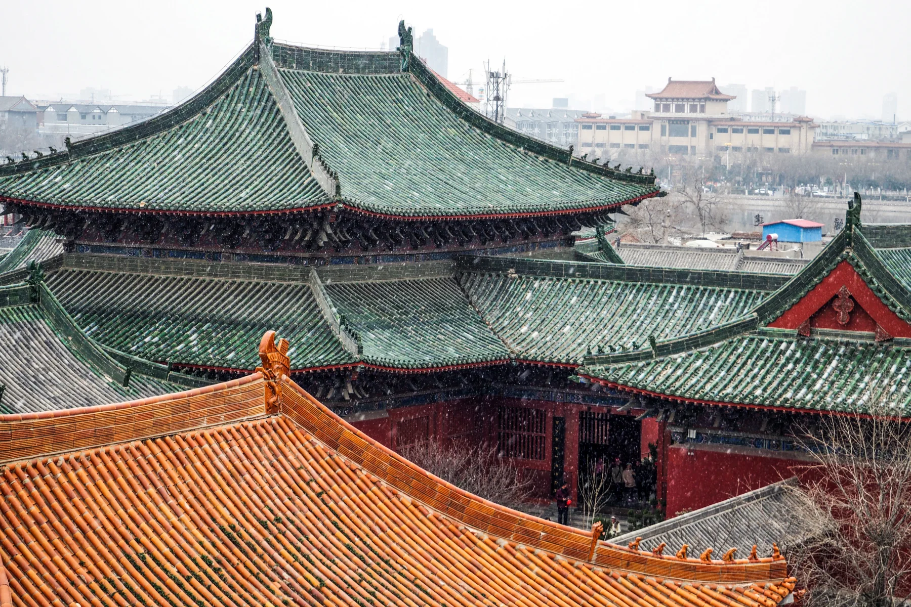 Green and orange roofs of the Bao Gong memorial complex after snow