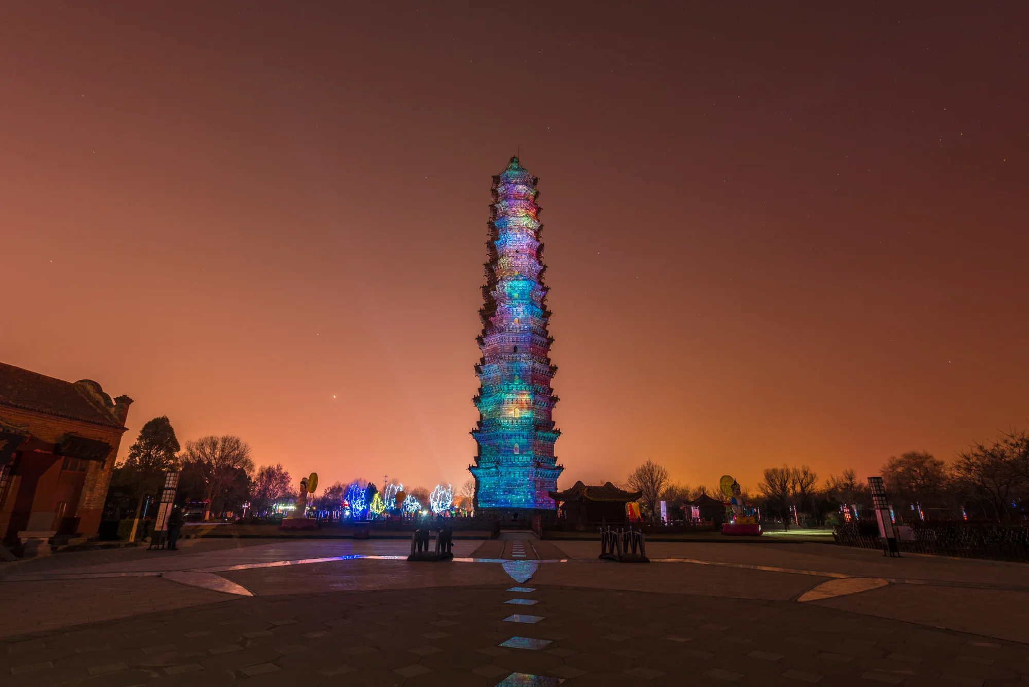 The dark glazed-brick Iron Pagoda illuminated against the night sky