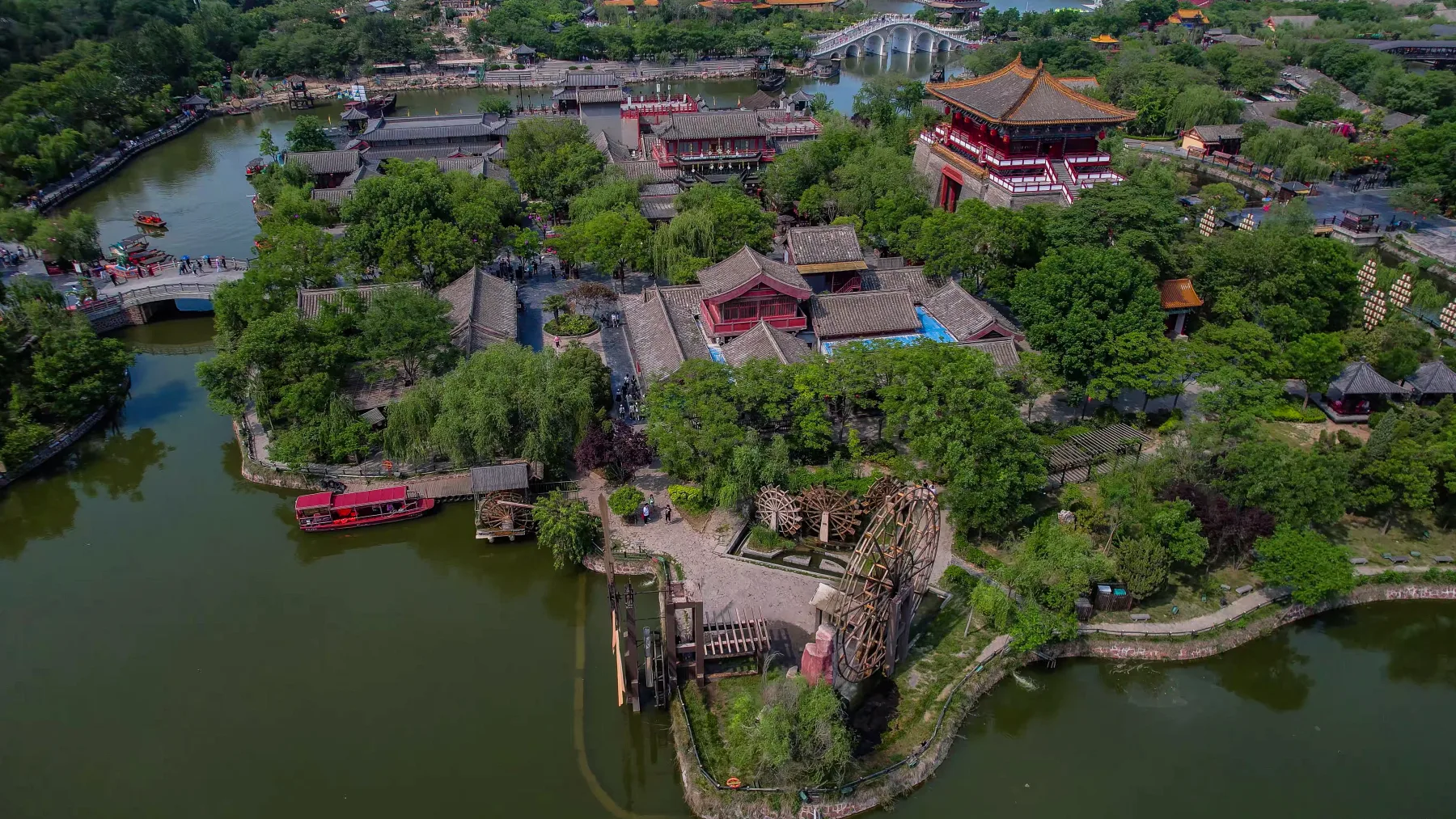 Waterwheel landscape and waterways inside the modern Qingming Riverside Garden
