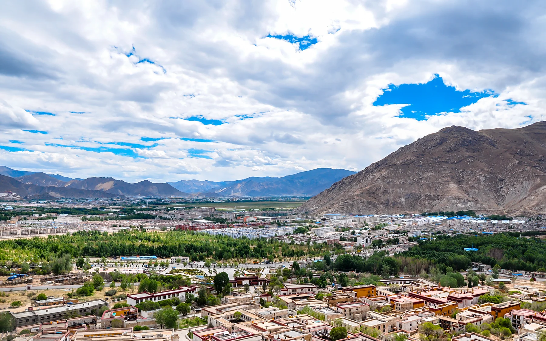 Sera monastery hills behind Lhasa, showing the city's sacred geography beyond the central monuments