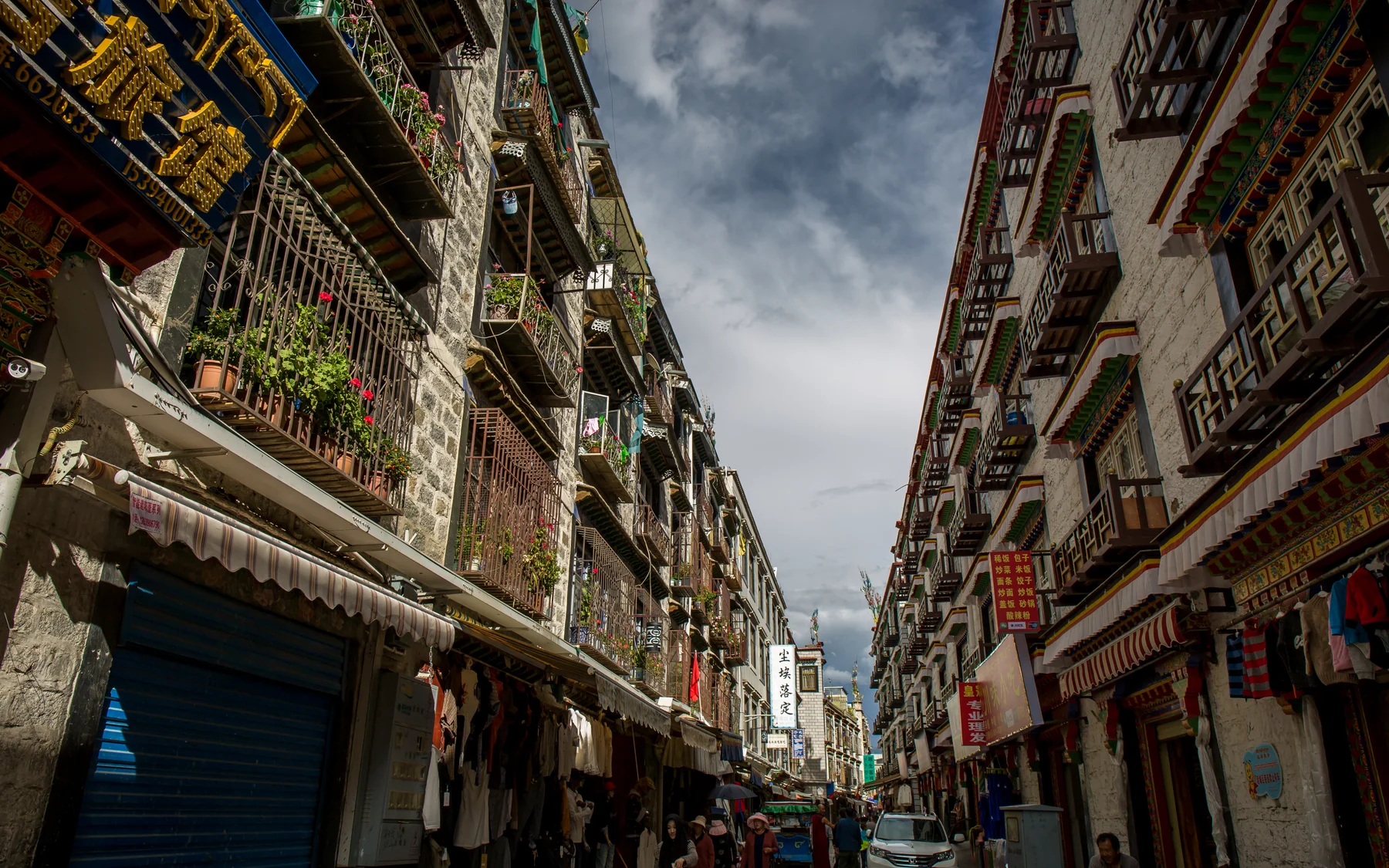 A Lhasa street scene beyond the monument postcard, with ordinary shops and daily traffic