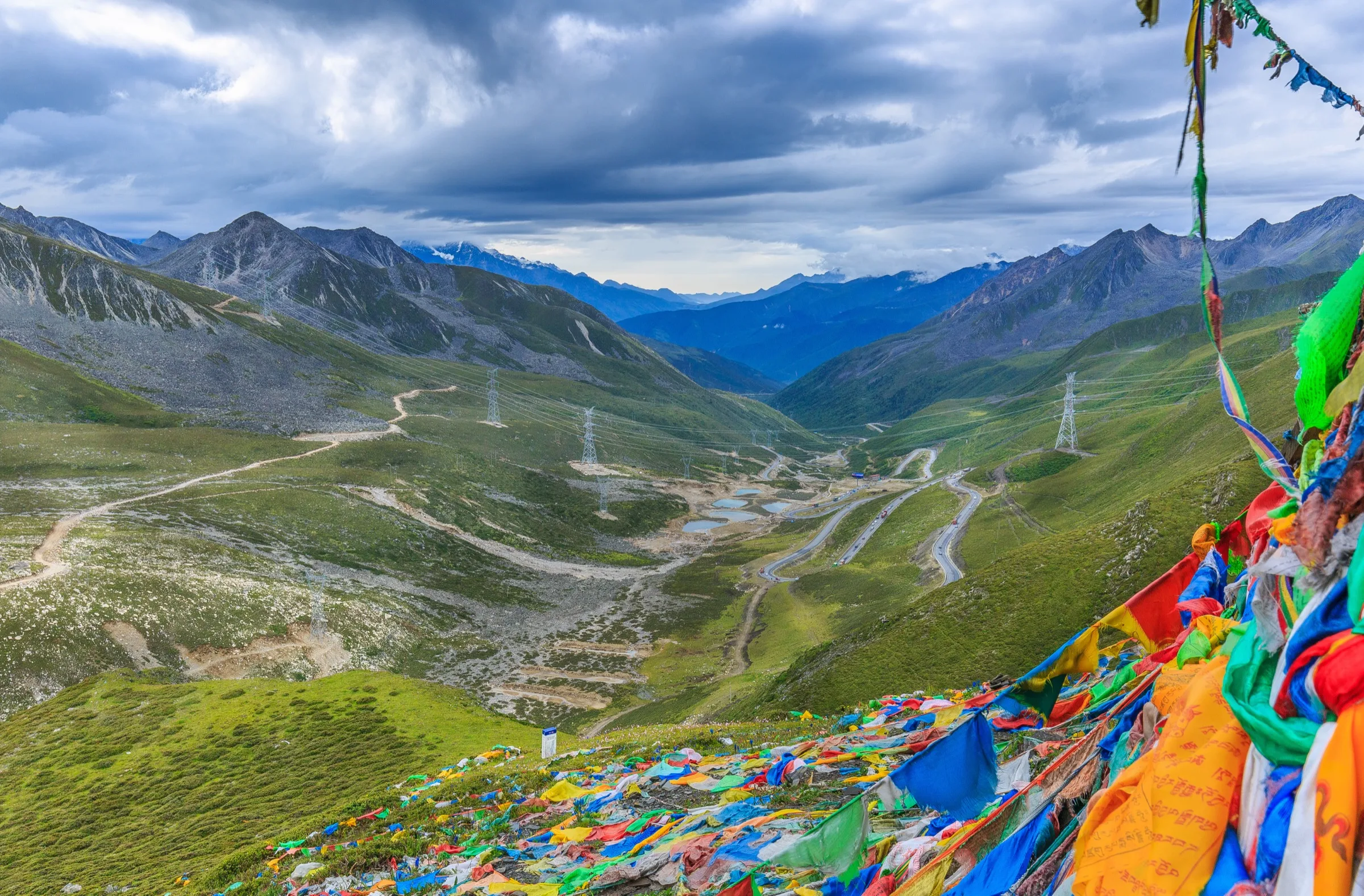 Tibetan prayer flags near Lhasa moving in the wind above a highland route